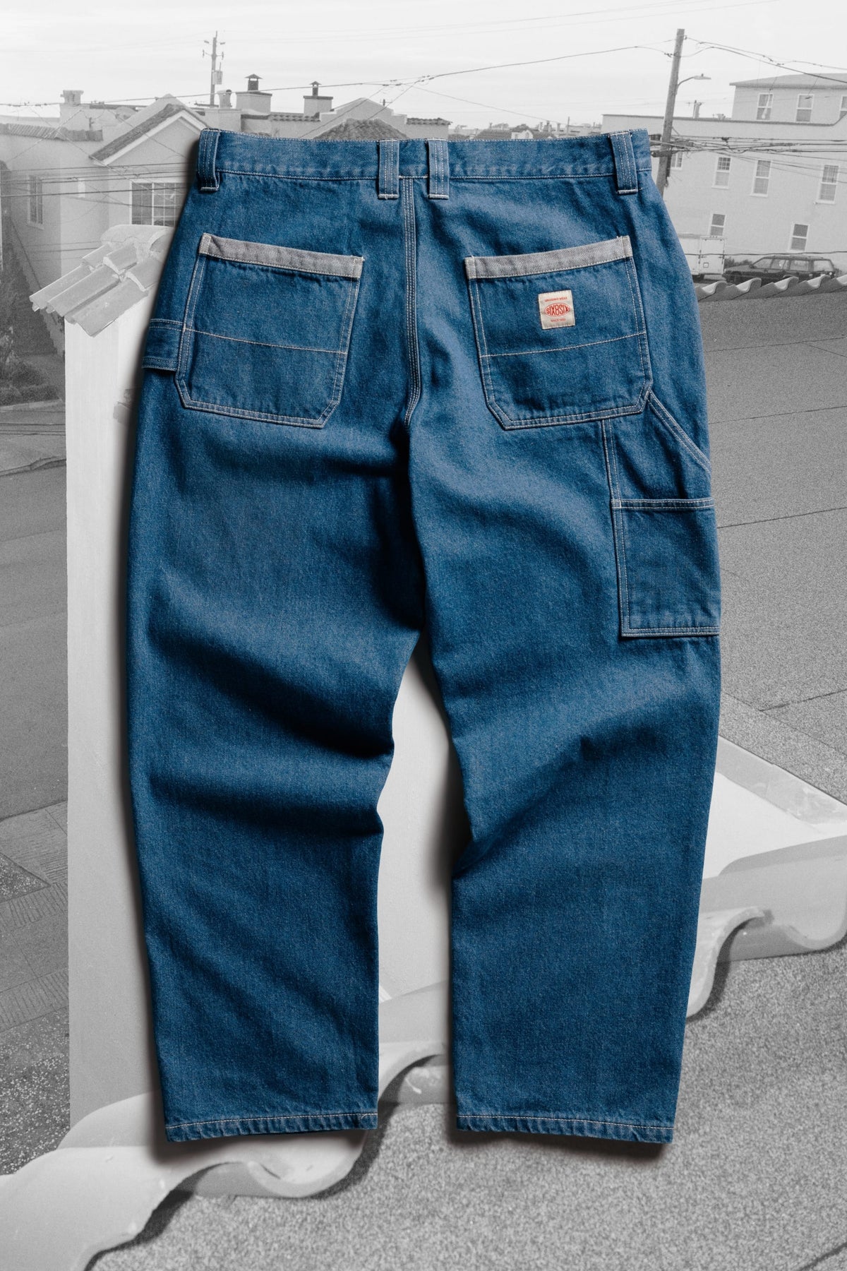 Back view of 686 Men’s Unwork® Hammerhead Denim Pant in blue, featuring a utility loop, two large back pockets, and a patch on the rear right pocket.