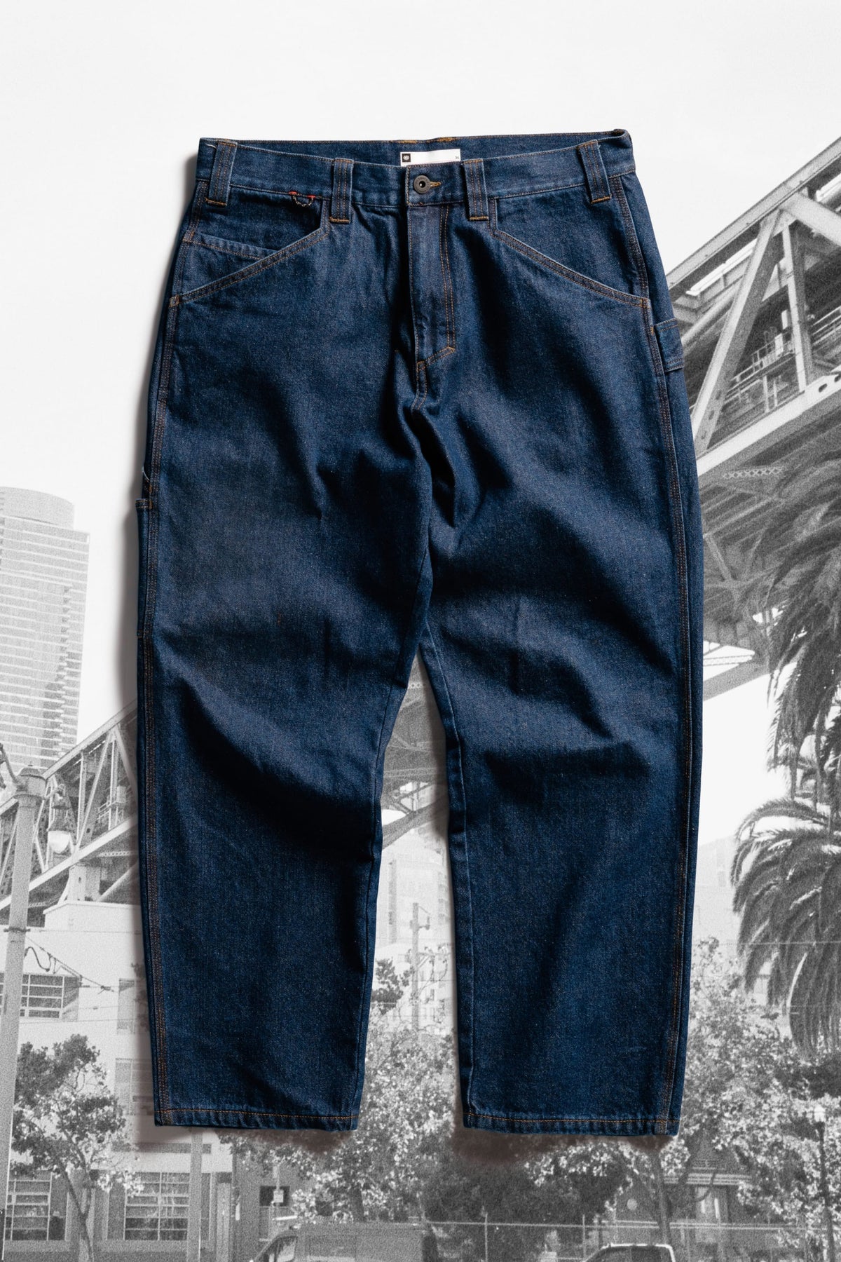 Dark blue 686 Men’s Unwork® Hammerhead Denim Pant utility work pants with front pockets, belt loops, and a button fly.