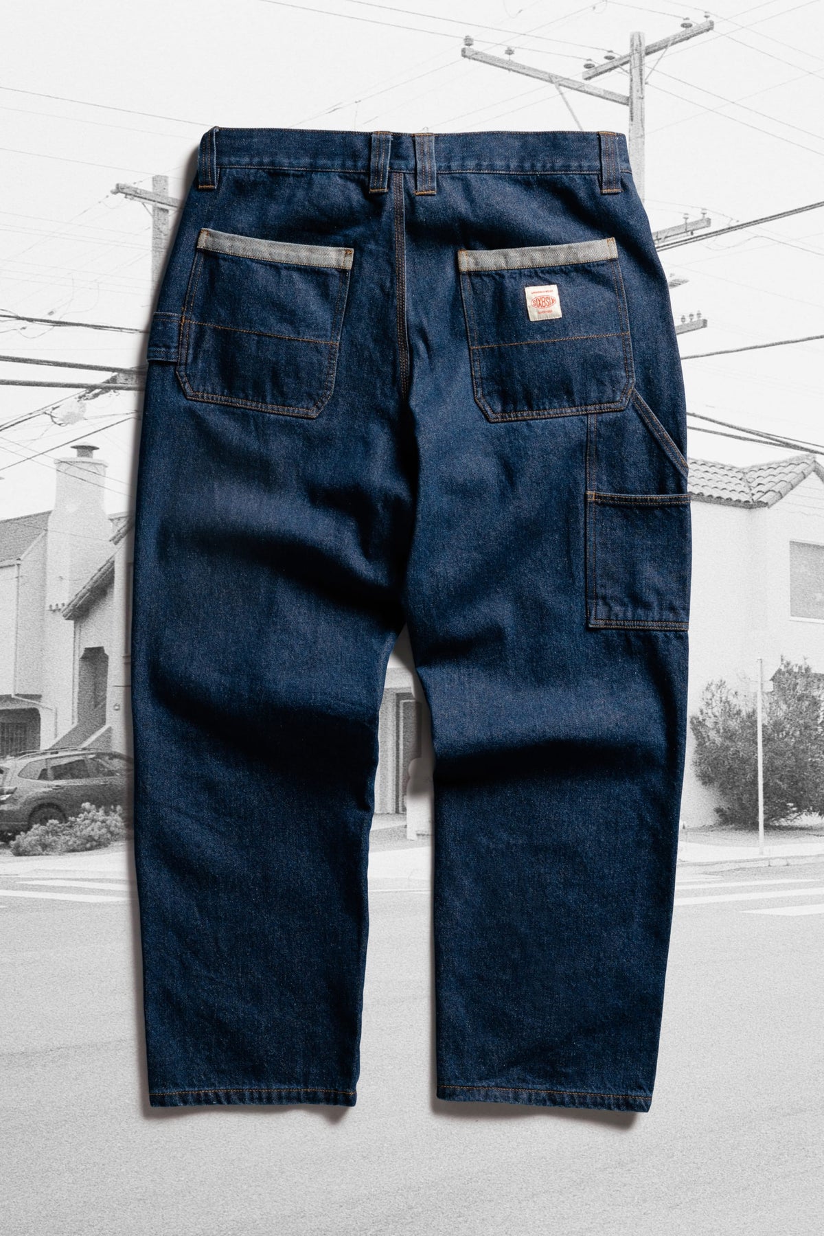 Back view of 686 Men’s Unwork® Hammerhead Denim Pant heavy-weight cotton work jeans, featuring two back pockets, a utility pocket on the leg, and a logo patch on the right pocket.