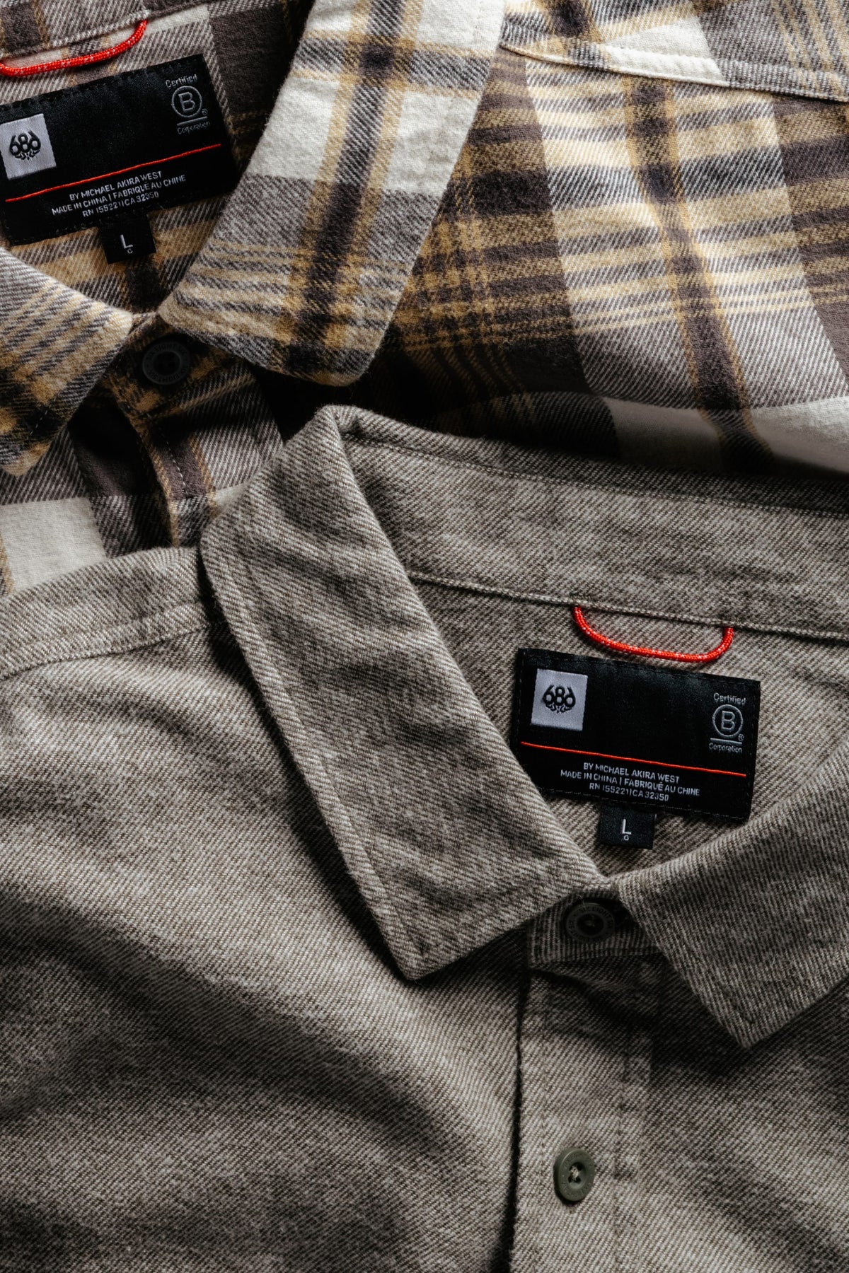 Two 686 Men’s SMARTY® Headwall Flannel shirts shown from the chest up: one in a solid grey knit and one in a brown and white plaid flannel.