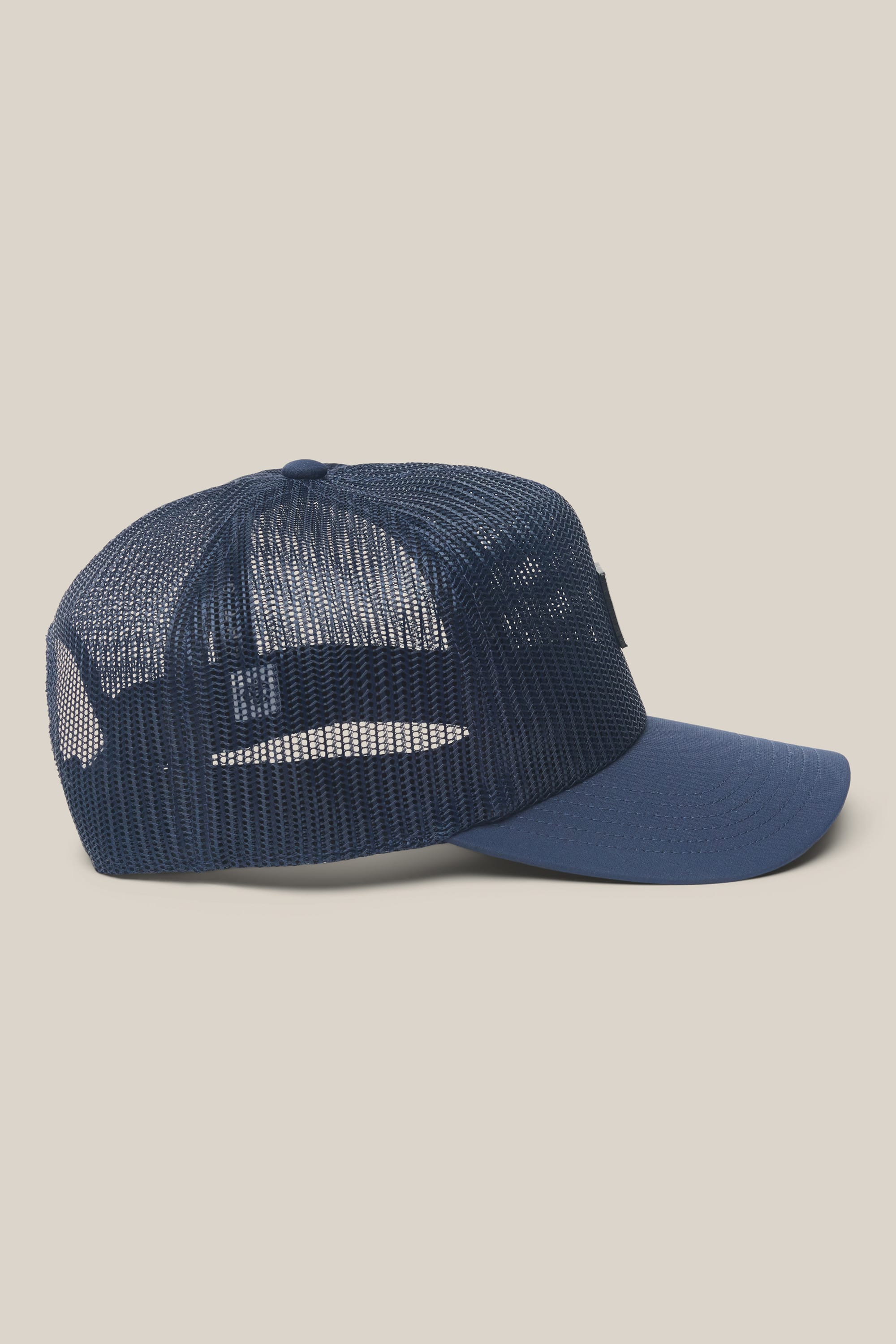 The 686 High-Pro Knockout Structured 5 Panel Hat by 686 is displayed from the side, showcasing its blue mesh design with a curved brim and a breathable netted back panel.