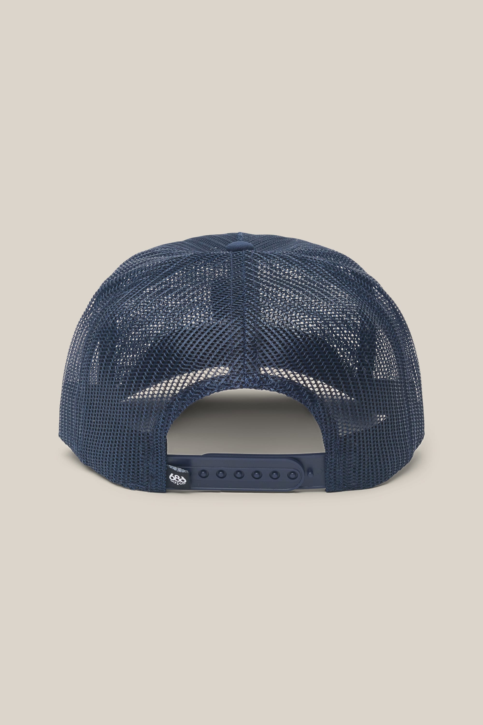 The 686 High-Pro Knockout Structured 5 Panel Hat by 686 is displayed from the rear, showcasing its navy blue mesh-back design and adjustable snapback closure. This classic men's hat is set against a plain beige background.
