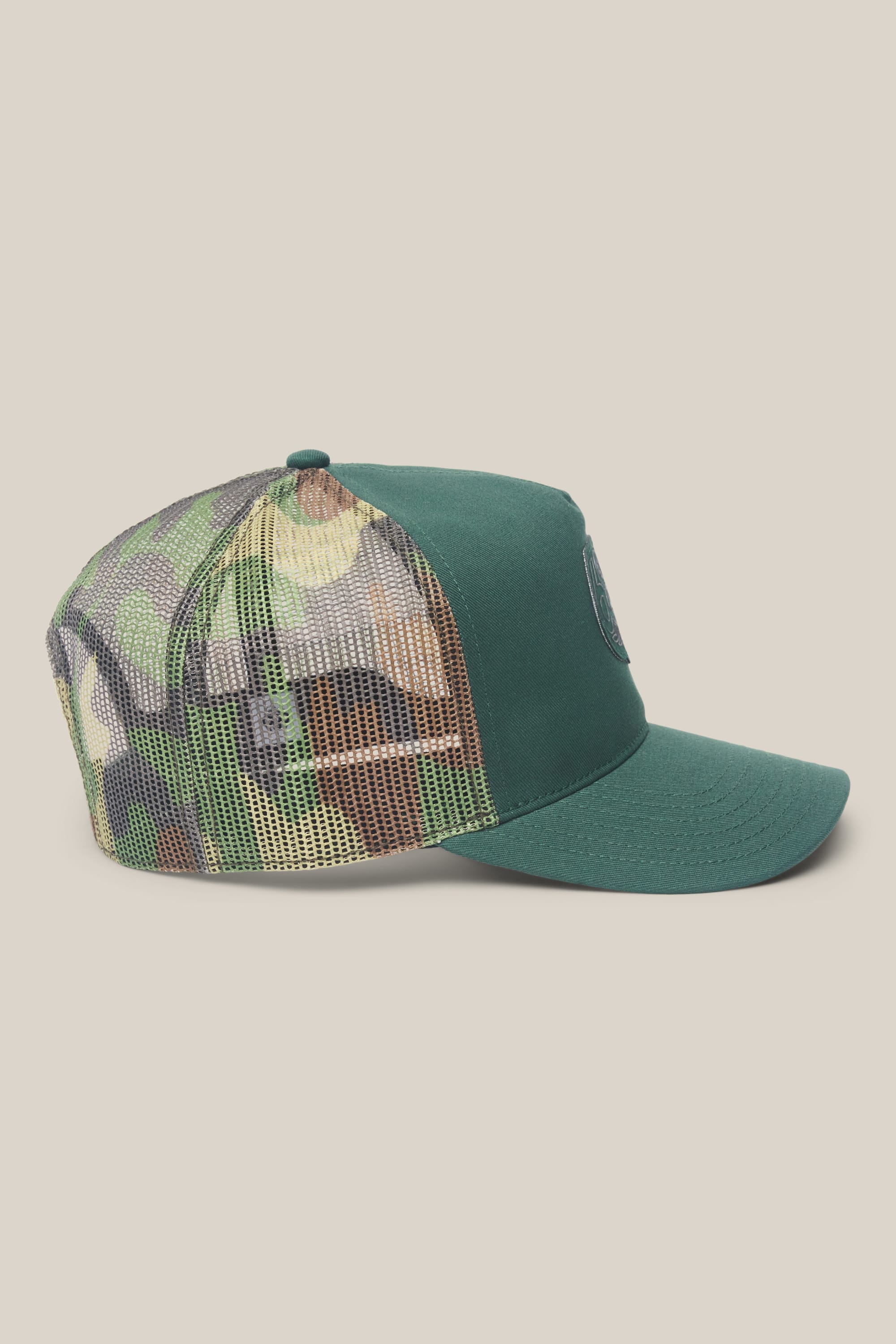 The 686 Mid-Pro Wreath Unstructured 5 Panel Mesh Hat by 686 is shown from the side on a plain, light background. It features a green solid front and brim with a camouflage mesh back in polyester-cotton woven fabric.