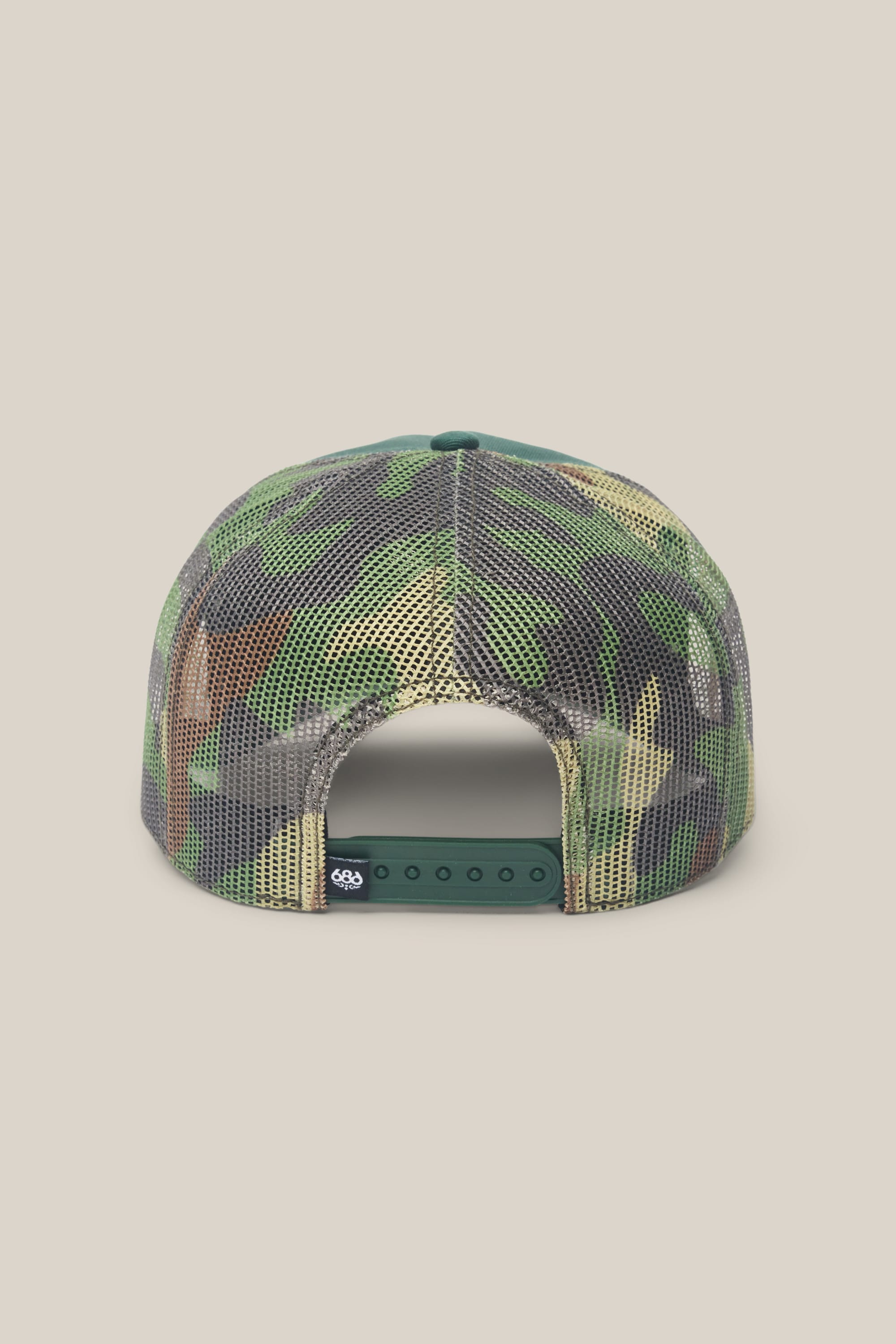 The 686 Mid-Pro Wreath Unstructured 5 Panel Mesh Hat by 686 is shown from the back, featuring a camouflage pattern, adjustable snapback closure, black tag on the strap, and set against a plain beige background.