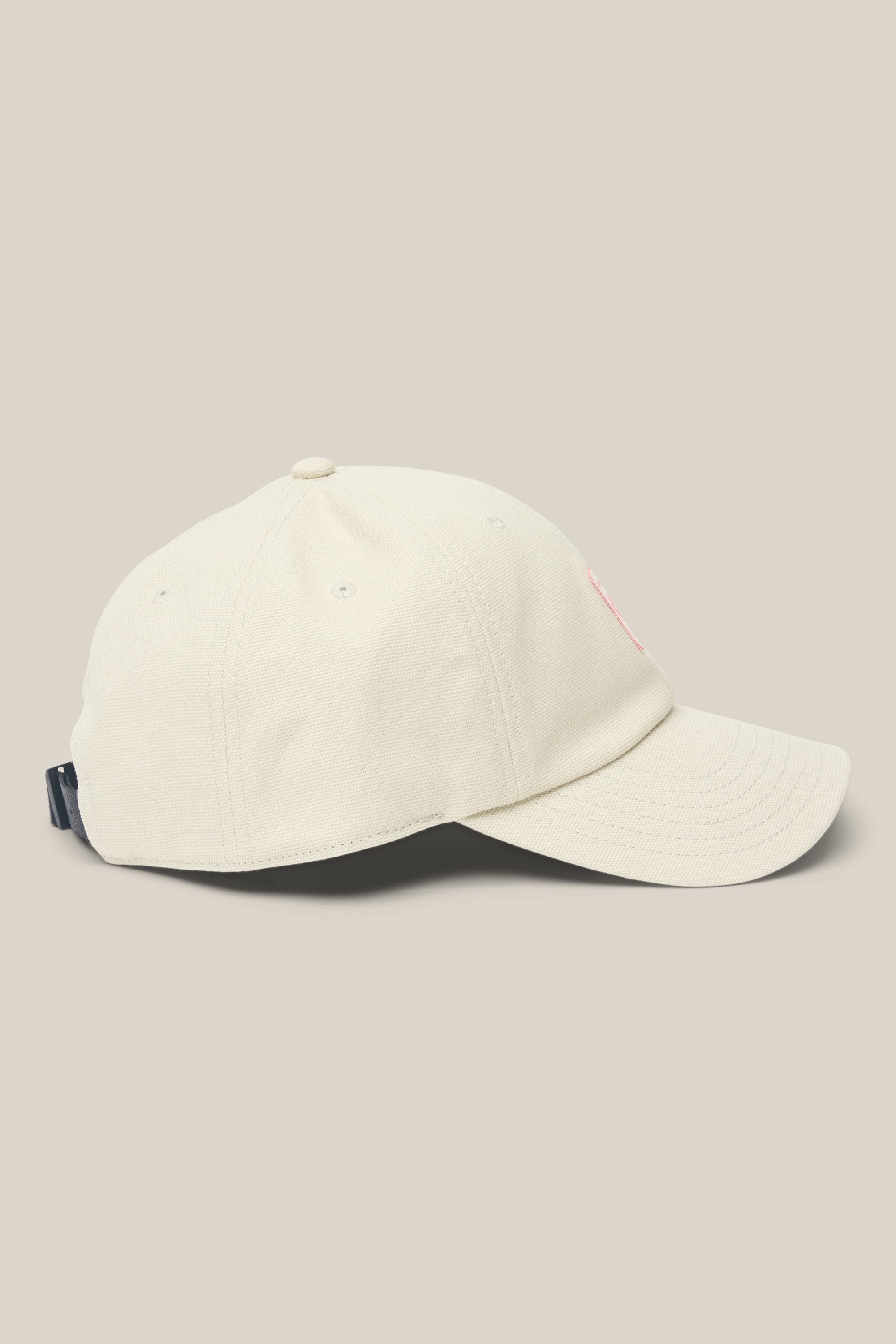 The 686 Low-Pro Unwork Unstructured 6 Panel Hat by 686, in light beige polyester cotton, features a classic baseball cap silhouette with side eyelet vents and a curved brim, shown against a plain beige background.
