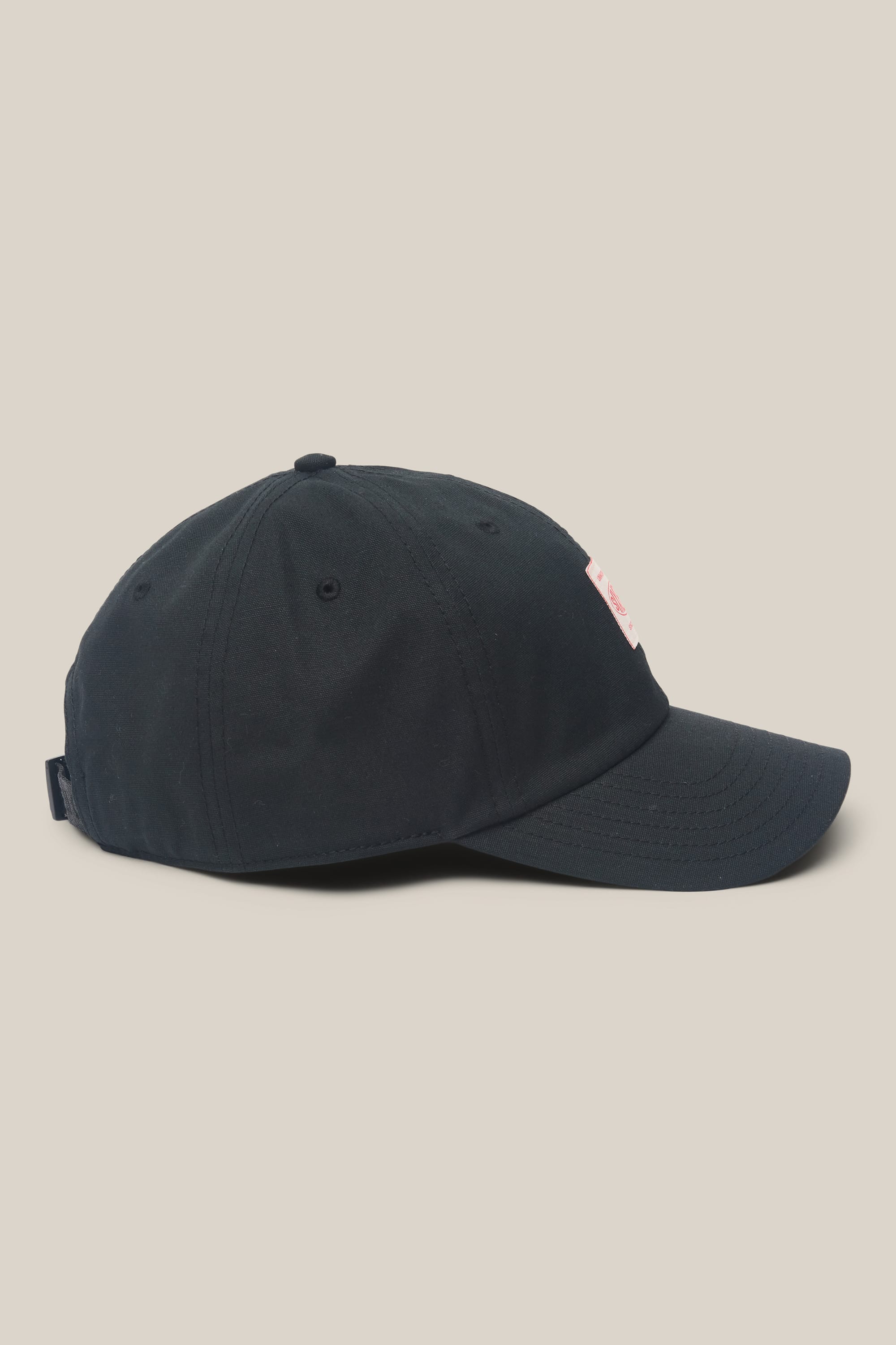 The 686 Low-Pro Unwork Unstructured 6 Panel Hat by 686 is a black men's hat made of polyester-cotton, shown from the side on a plain light background. It has a curved brim and a small rectangular patch on the front.