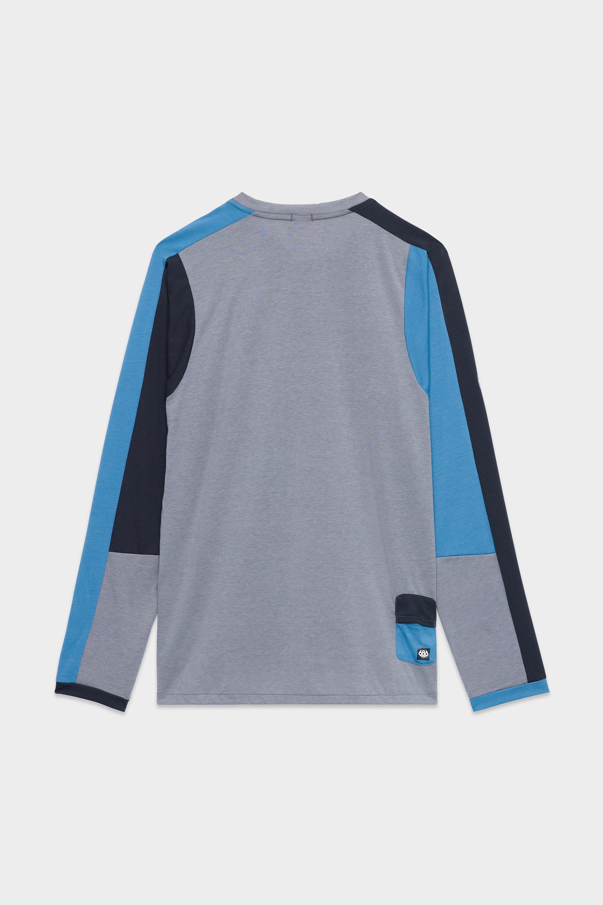 The 686 Mens Rival Long Sleeve Bike Jersey by 686 features a patchwork design in gray, blue, and navy shown from the back, with a small patch near the lower right hem.
