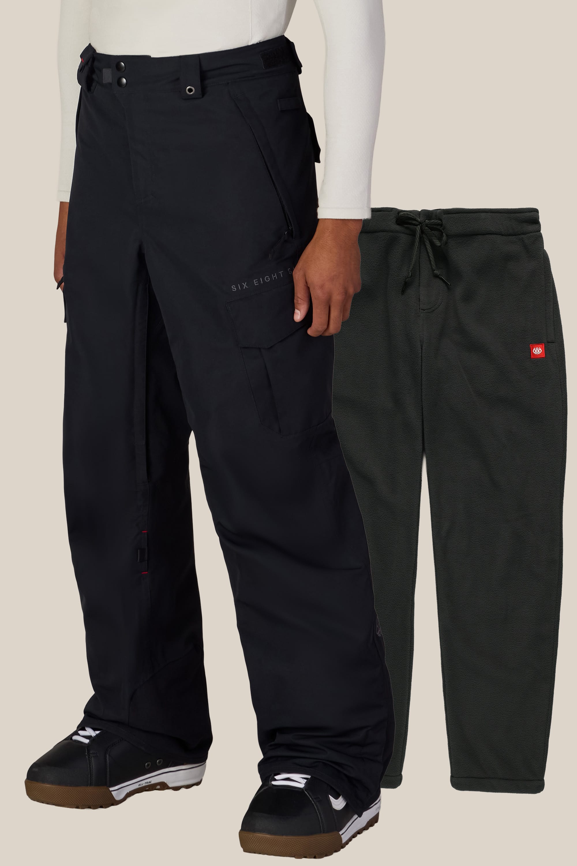 A person wearing 686 black snow pants and black snow boots stands next to a pair of dark green 686 Men’s SMARTY® 3-in-1 Cargo Pants displayed separately.