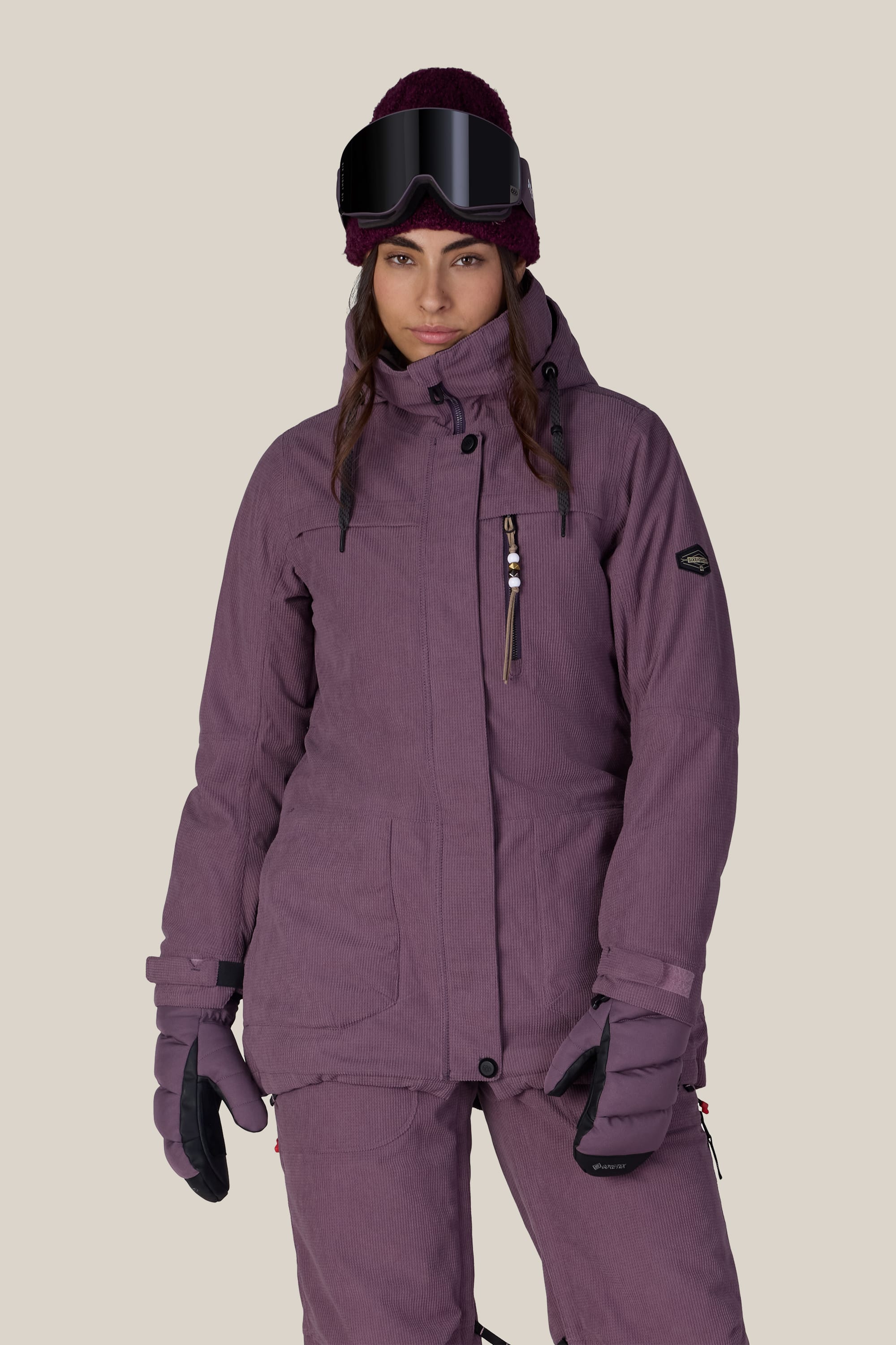 A person wearing the 686 Women’s Spirit Insulated Jacket stands against a plain light background, facing forward with a neutral expression.