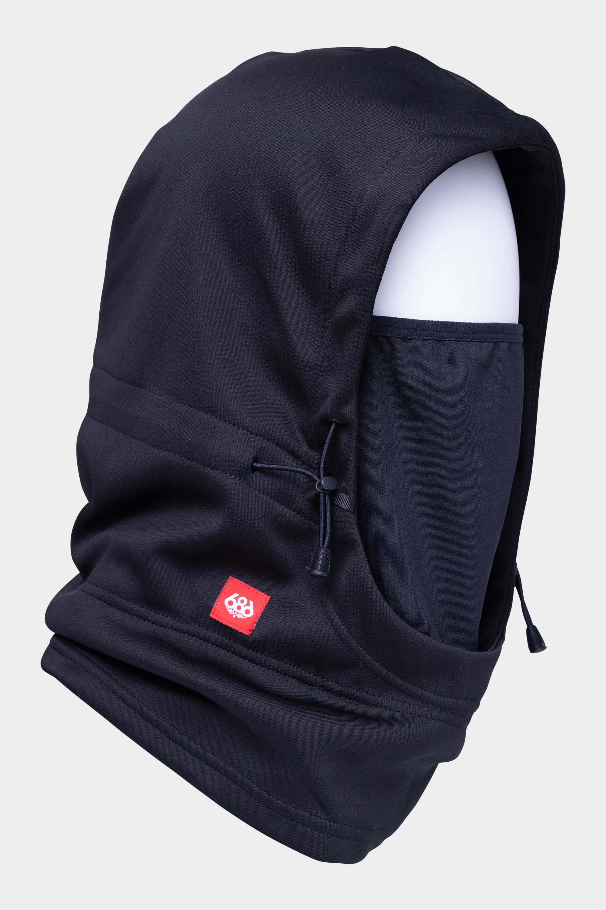 The 686 Patriot Bonded Hood by 686 is a black hooded balaclava featuring adjustable drawstrings and a red logo patch, shown on a white mannequin head against a plain light background.