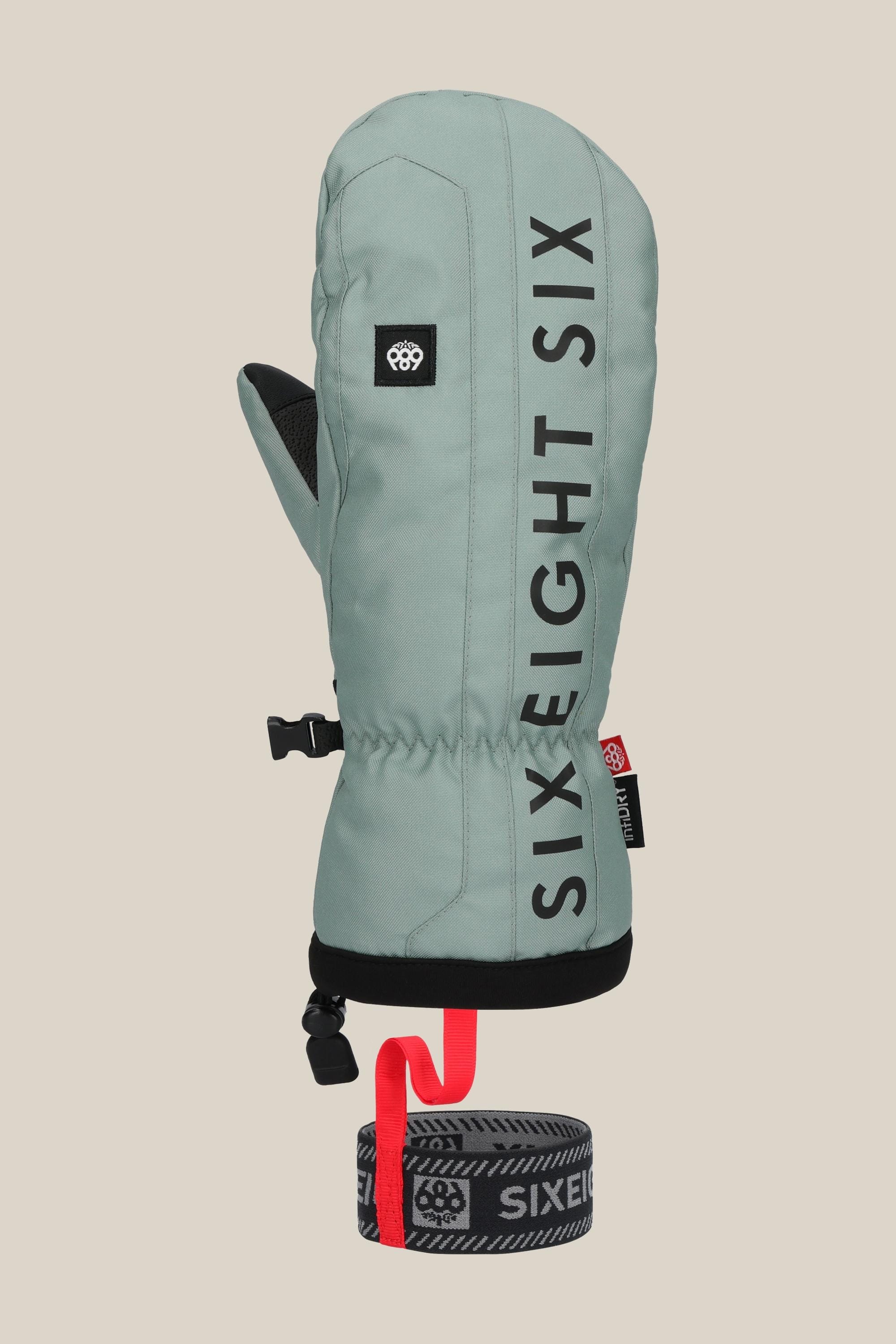 The 686 Mens Team Merino Mitt is a sage green winter mitten featuring black vertical SIX EIGHT SIX text, a small logo patch, black trim, internal finger separation for warmth, and an attached black-and-red wrist leash.