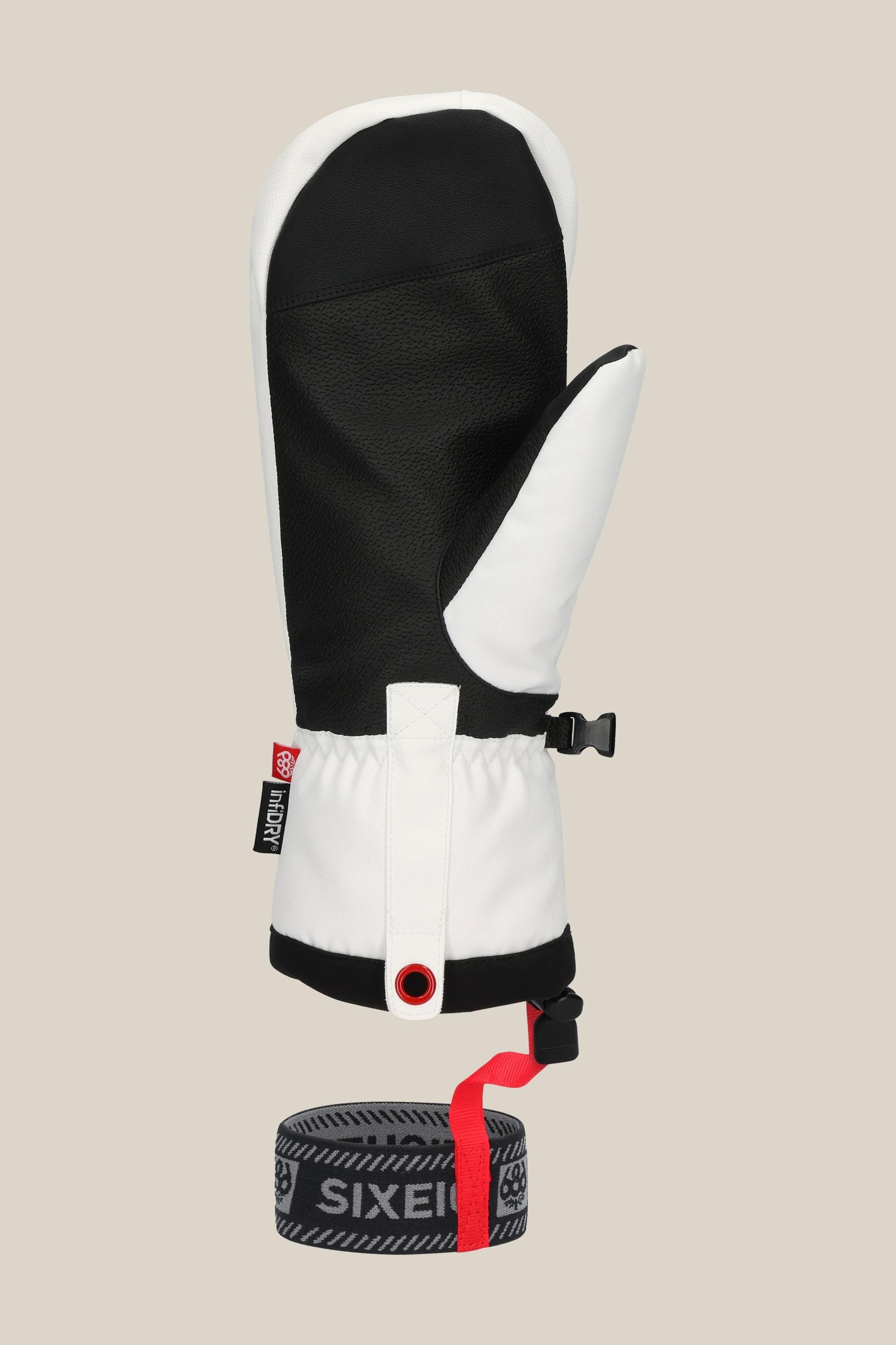 The 686 Mens Team Merino Mitt features black and white insulation for extra warmth, a textured palm, adjustable wrist strap, and a gray/black 686-branded wrist leash with a red loop, all shown on a beige background.