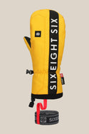 The 686 Mens Team Merino Mitt by 686 is yellow with a black vertical stripe and white SIXEIGHT SIX text, has internal finger separation for warmth, an adjustable strap, and a detachable wrist leash with a red loop.