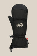 The 686 Women's Jubilee™ Mitt is a black winter mitten with light insulation, a stitched white 686 logo on the back, a black buckle clip at the wrist, and a small red and black tag on the side, shown against a beige background.