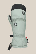 The 686 Women's Jubilee™ Mitt by 686 is a light gray waterproof mitten featuring a black thumb tip and top, flower and smiling face embroidery, elastic wrist, clip, and a red cuff tag. Shown against a beige background.