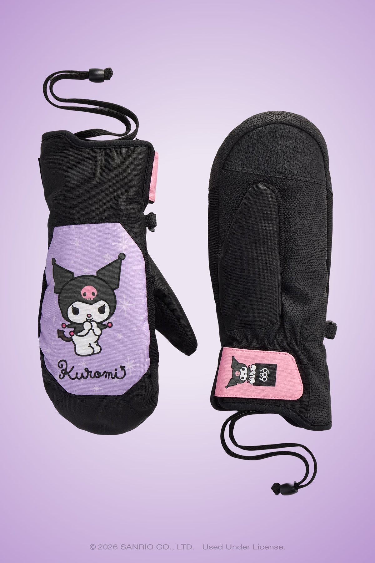 Two black and purple 686 Women’s Revel Mitts with Kuromi character art, pink trim, and adjustable wrist cords from 686 are displayed on a lavender background. One mitten displays the front design, while the other shows the palm side.