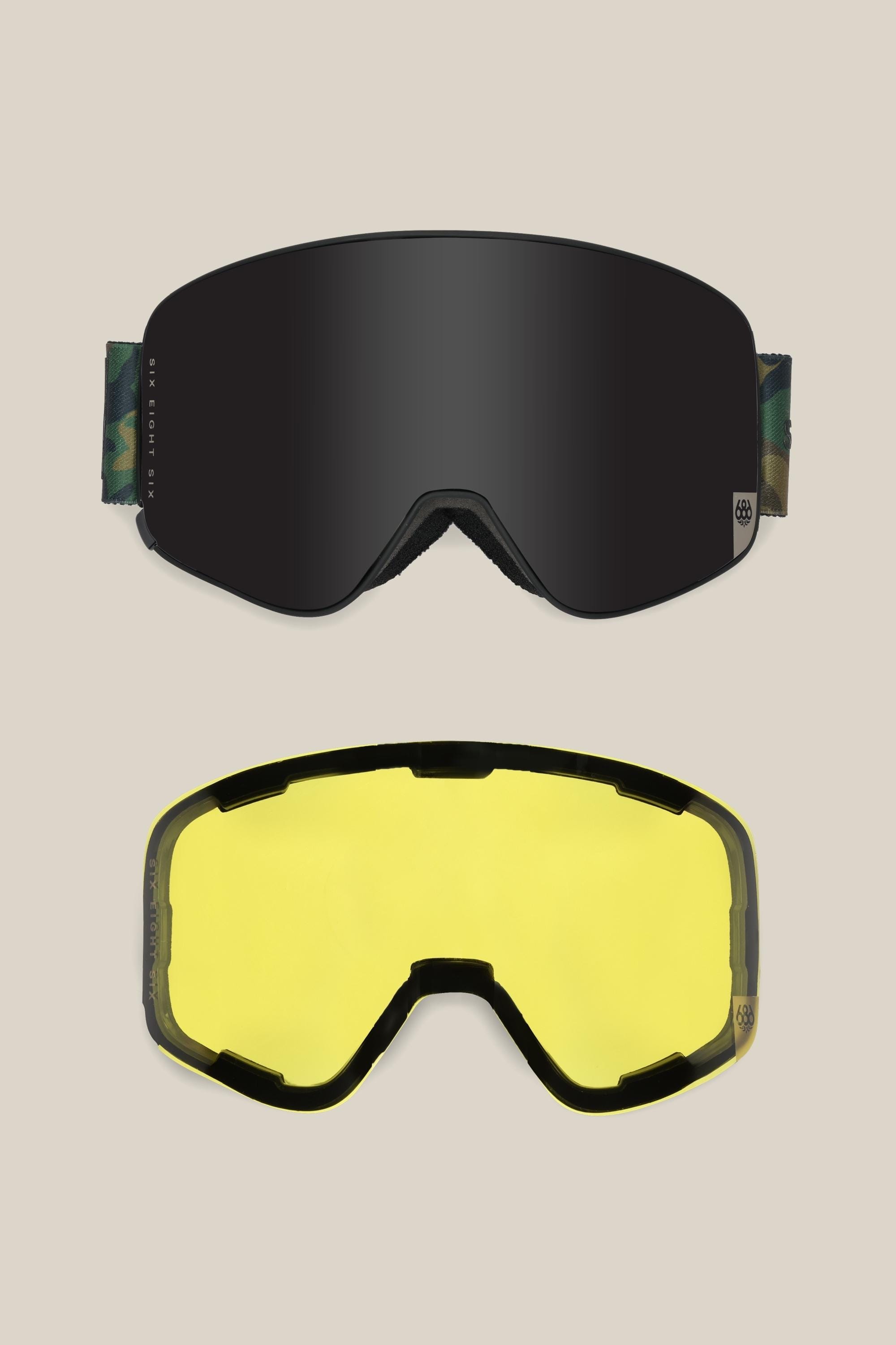 Two 686 SMARTY® Magnetic Goggle lenses by 686 are shown: the top with a dark, reflective tint, and the bottom in bright yellow. Both have a curved, wraparound design and are compatible with interchangeable magnetic lenses.