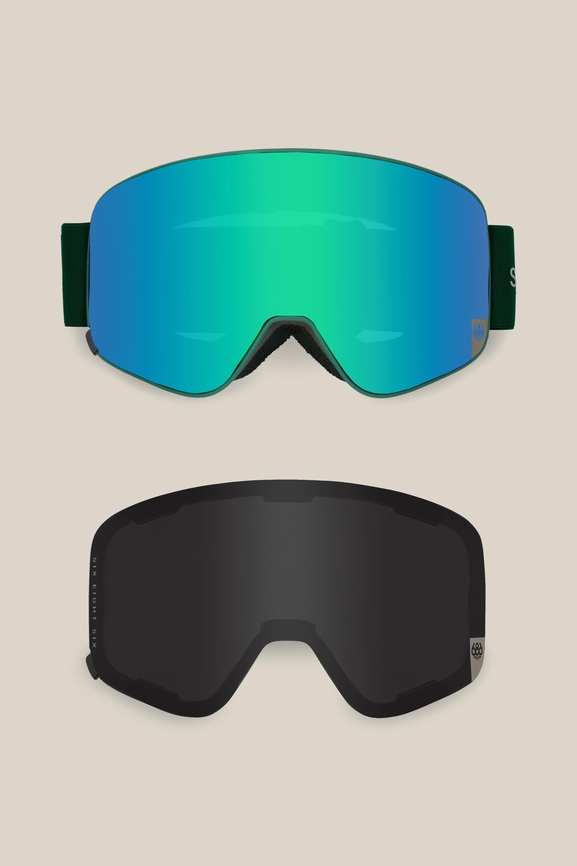 Two pairs of 686 SMARTY¨ Magnetic Goggles by 686 are shown: the top with a reflective green-blue lens, the bottom with a dark tinted lens. Both have wide straps and frameless, minimalist designs on a neutral background.