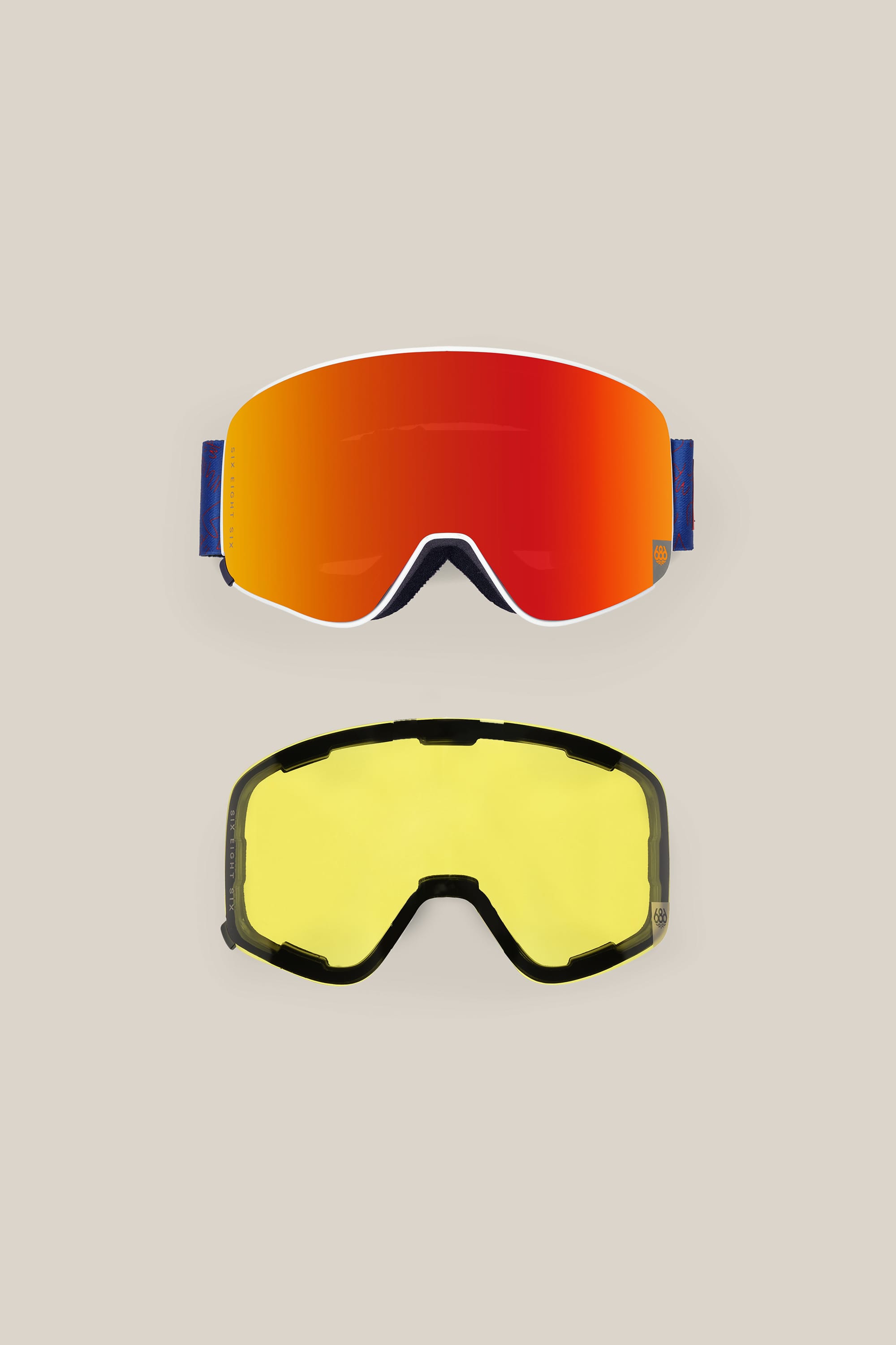 Two 686 SMARTY® Magnetic Goggles by 686 are displayed on a light beige background: the top pair has a red-orange reflective lens, while the bottom features a minimalist design with a yellow interchangeable lens and dark frame.