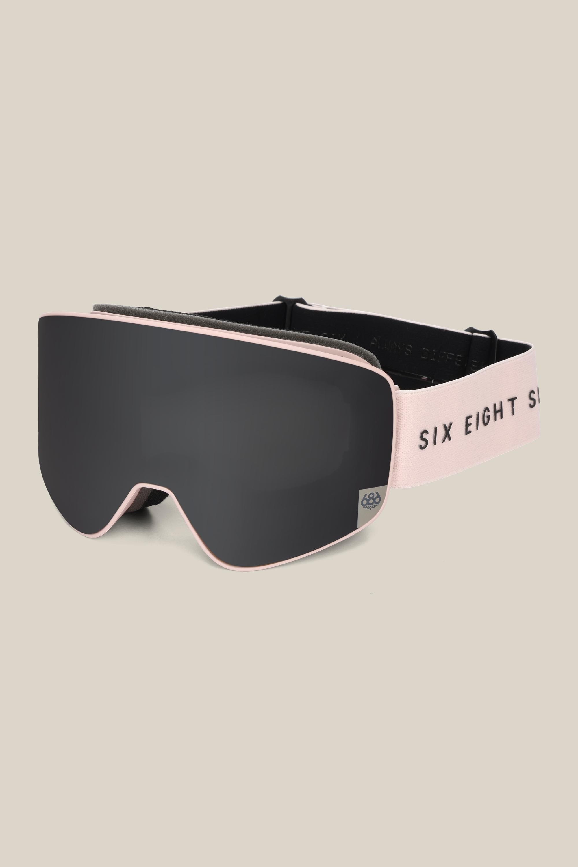 The 686 SMARTY® Magnetic Goggle features a sleek black minimalist design, wide tinted lens, light pink frame, and an adjustable "SIX EIGHT SIX" strap—offering easy use on the slopes.
