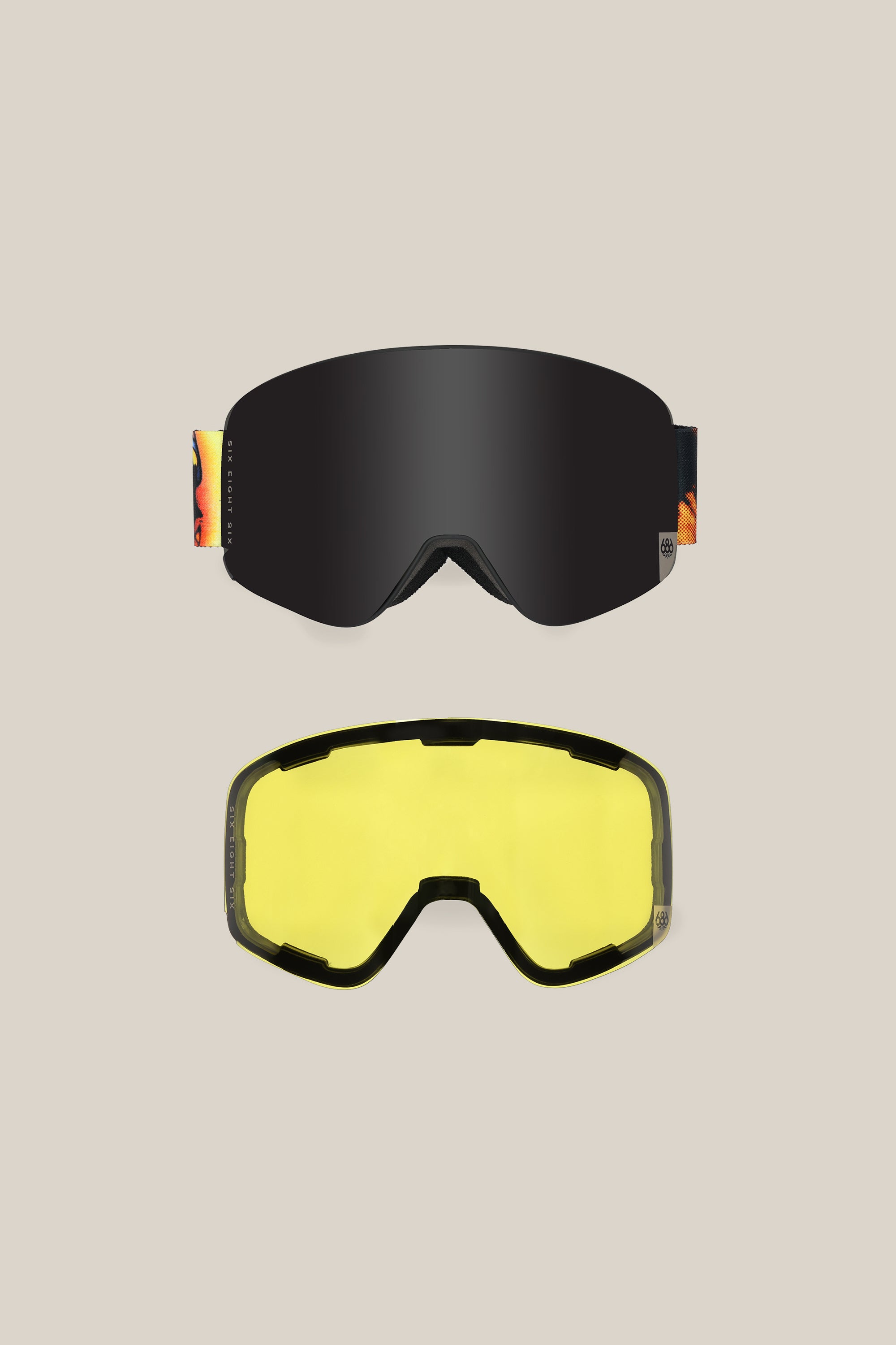 Two 686 SMARTY¨ Magnetic Goggles on a beige background: the top pair has magnetic lenses and a colorful strap; the bottom features a minimalist design with yellow-tinted, interchangeable lenses and a sleek black frame.