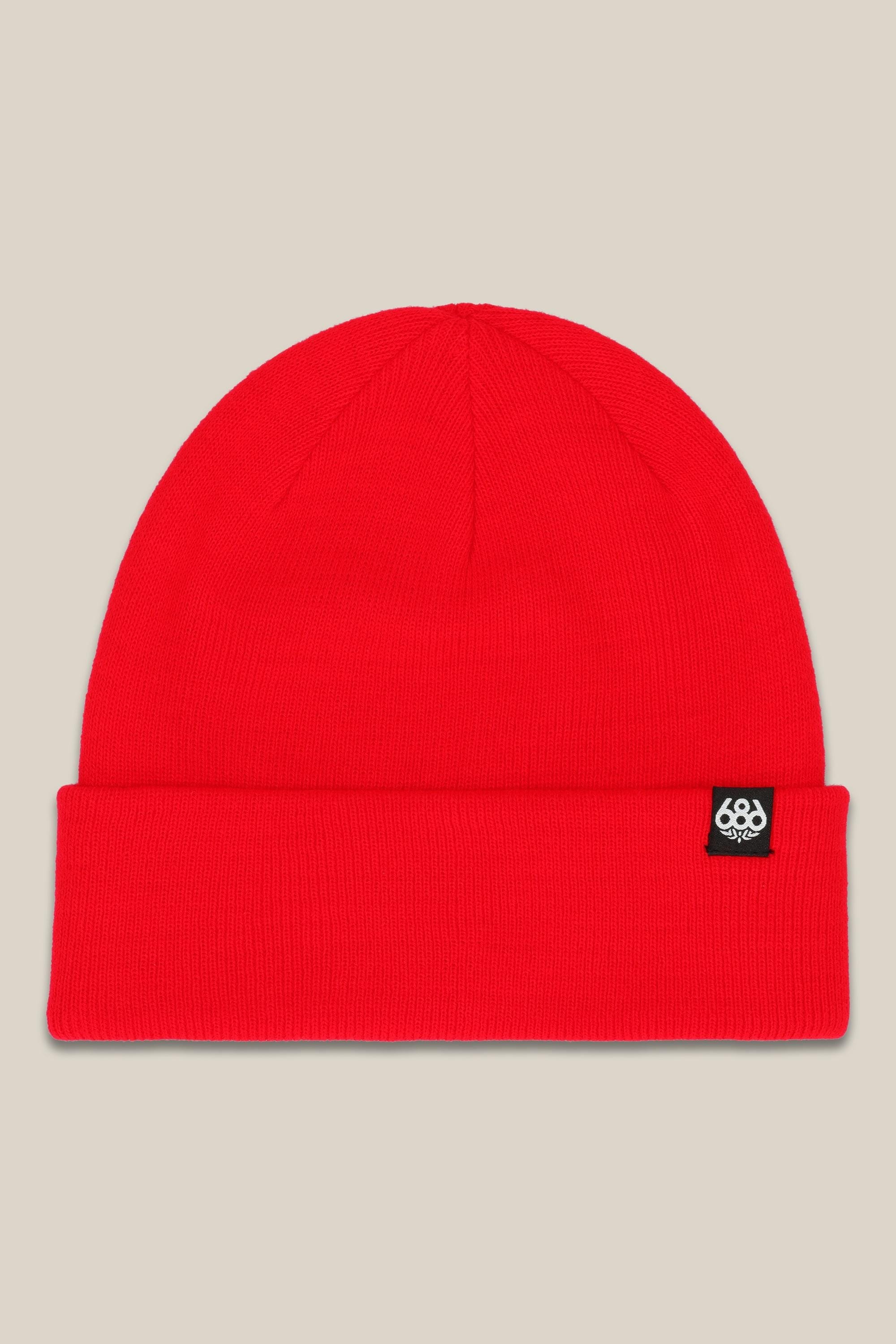 The 686 Standard Roll Up Beanie by 686 is a bright red knit hat with a folded brim and a small black rectangular cuff tag featuring a white logo. Displayed on a plain beige background.