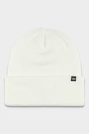 The 686 Standard Roll Up Beanie by 686 is a white knitted hat with a folded brim and a small black rectangular tag featuring a white logo on the front.