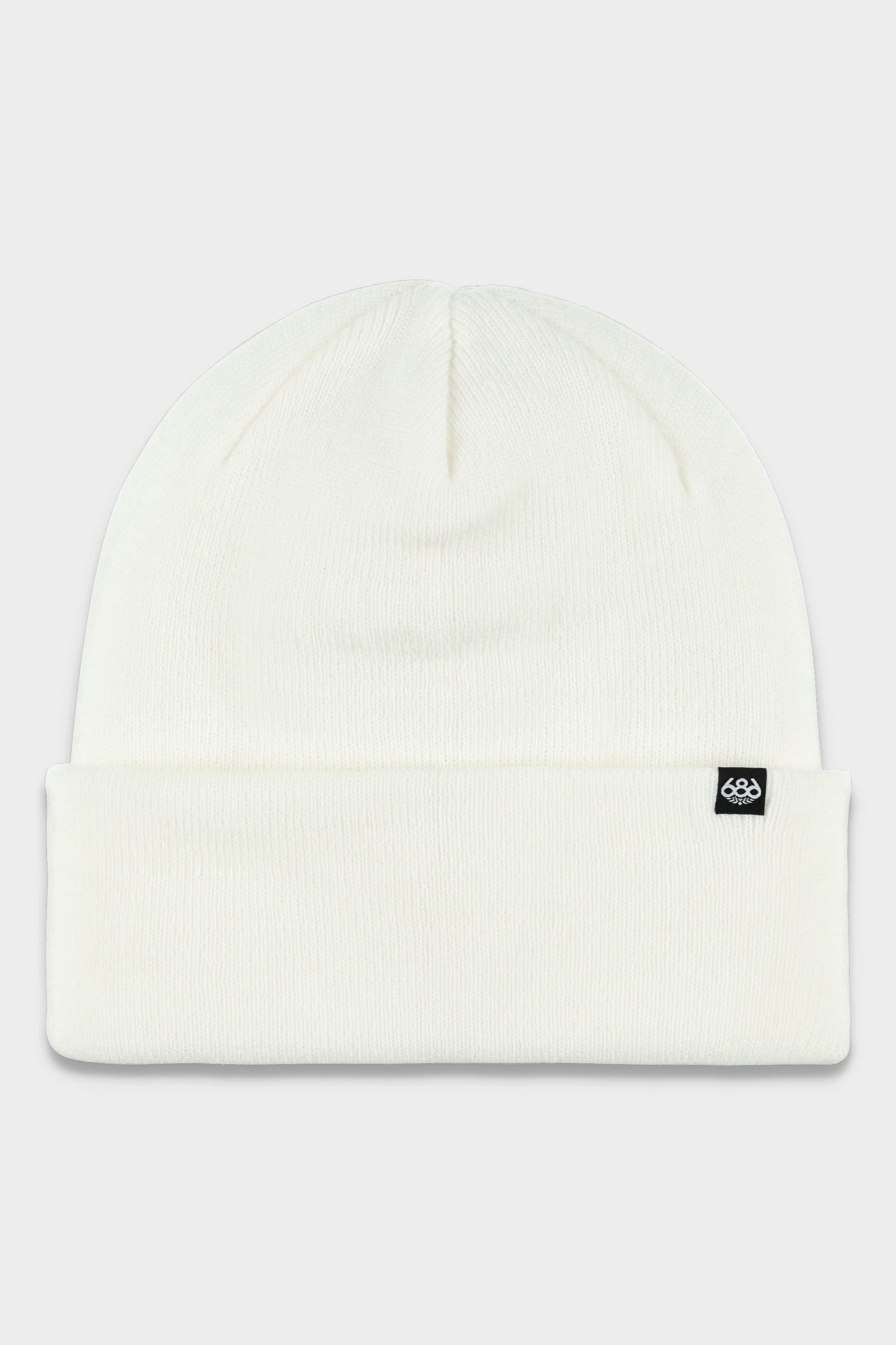 The 686 Standard Roll Up Beanie by 686 is a white knitted hat with a folded brim and a small black rectangular tag featuring a white logo on the front.