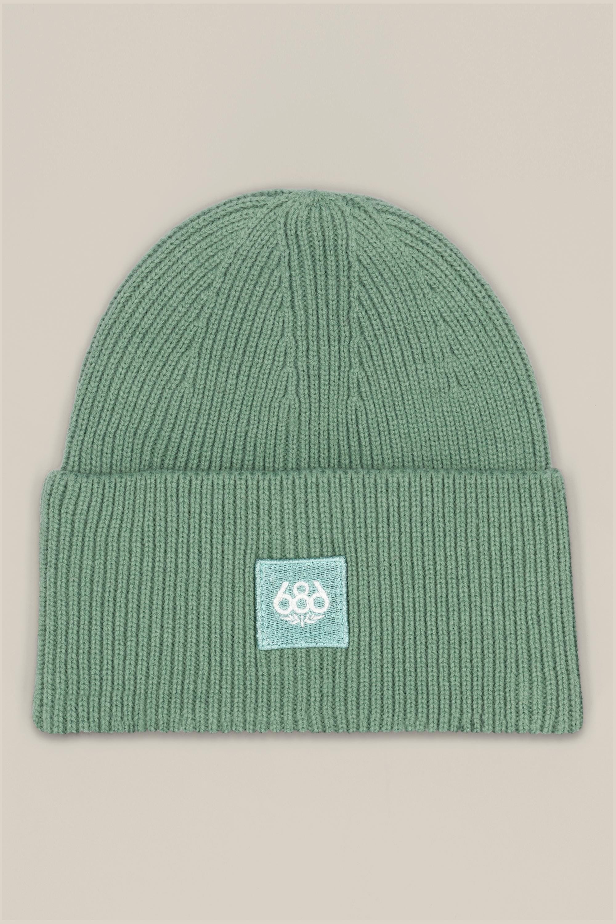 The 686 Big Cuff Beanie by 686 is a green knit hat with a wide folded cuff and a white patch featuring 686 in stylized text, shown on a plain beige background.