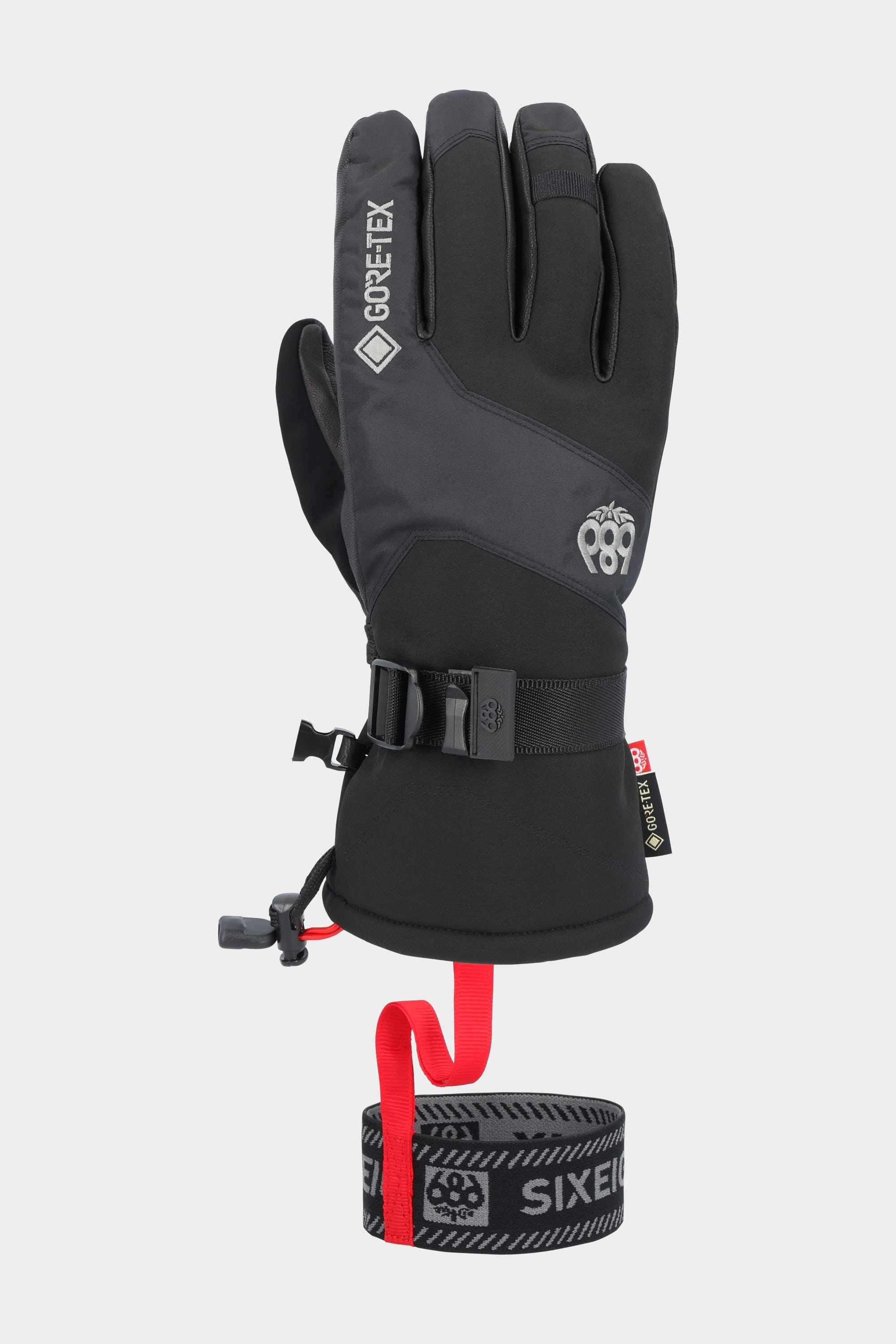 The 686 Men's GORE-TEX Leather Linear™ Glove features a leather palm, adjustable wrist strap, buckle, red safety leash on a rolled black and gray band, plus reinforced knuckles and fingertips for enhanced durability and waterproofing.