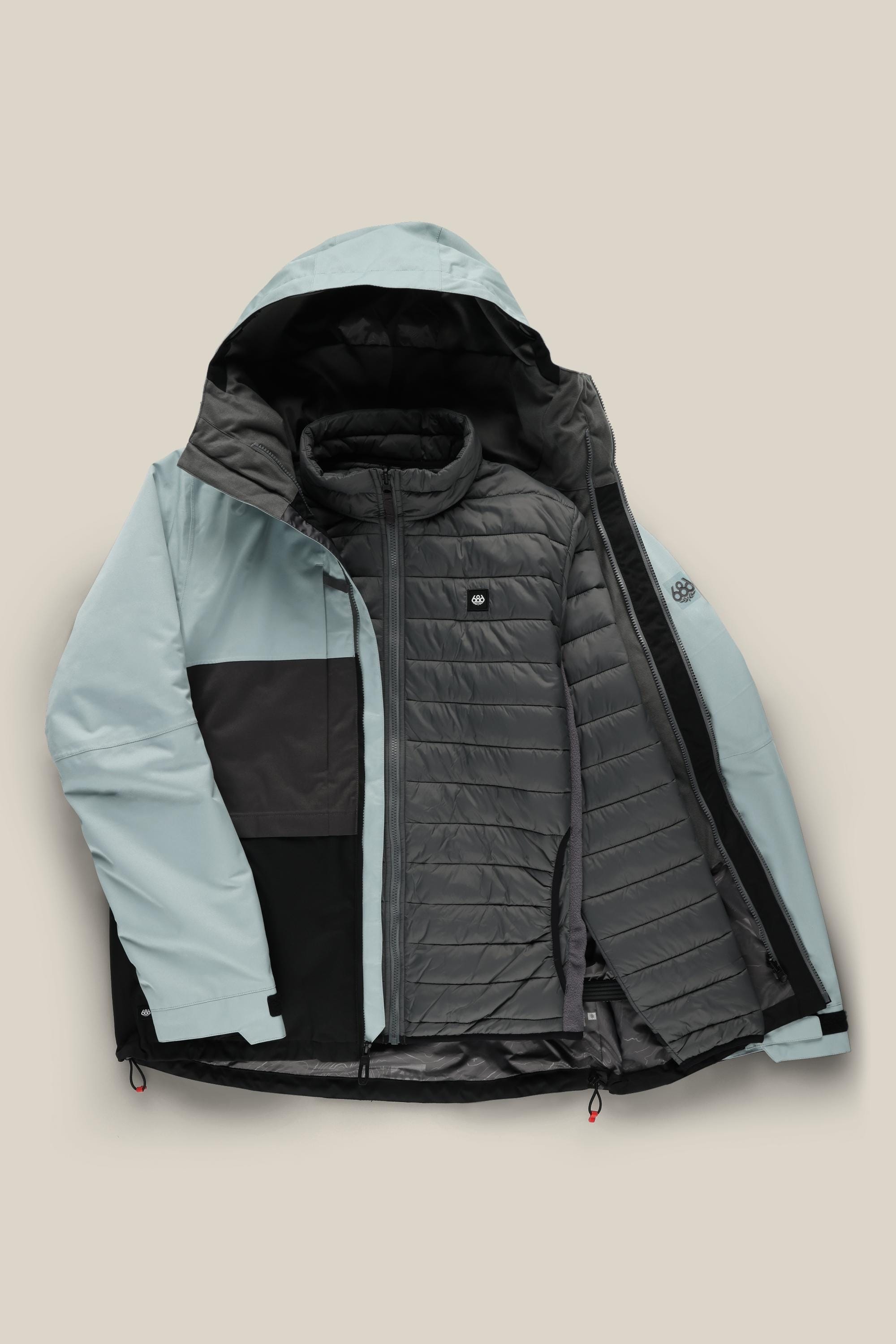 The 686 Men's SMARTY® 3-In-1 Form Jacket by 686, in light blue and black, is unzipped to show its quilted dark gray inner layer. This polyester waterproof jacket is displayed flat on a beige background.