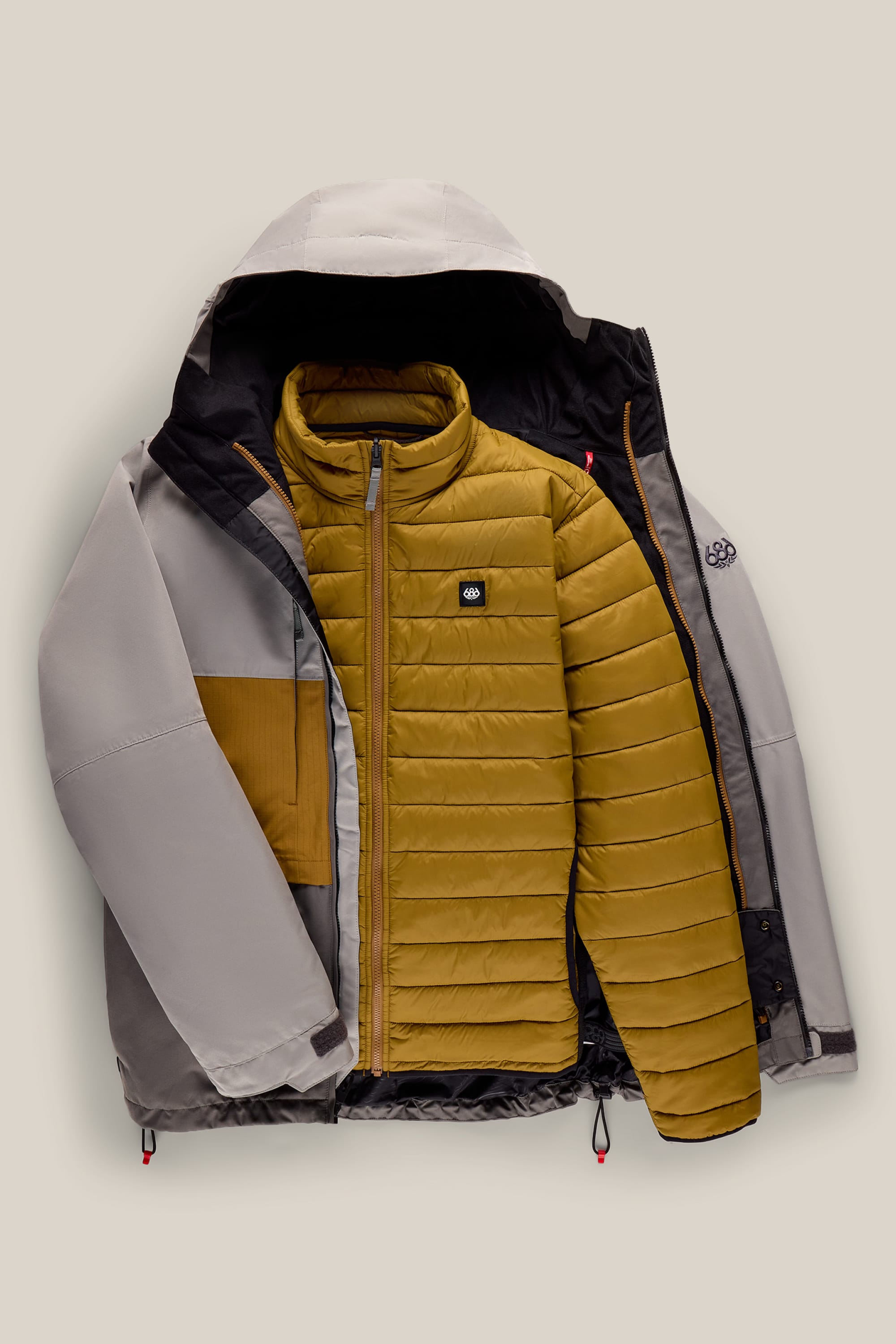 The 686 Men’s SMARTY® 3-In-1 Form Jacket by 686 is shown laid open, revealing its mustard yellow quilted inner jacket with a zipper and a small logo patch on the chest.