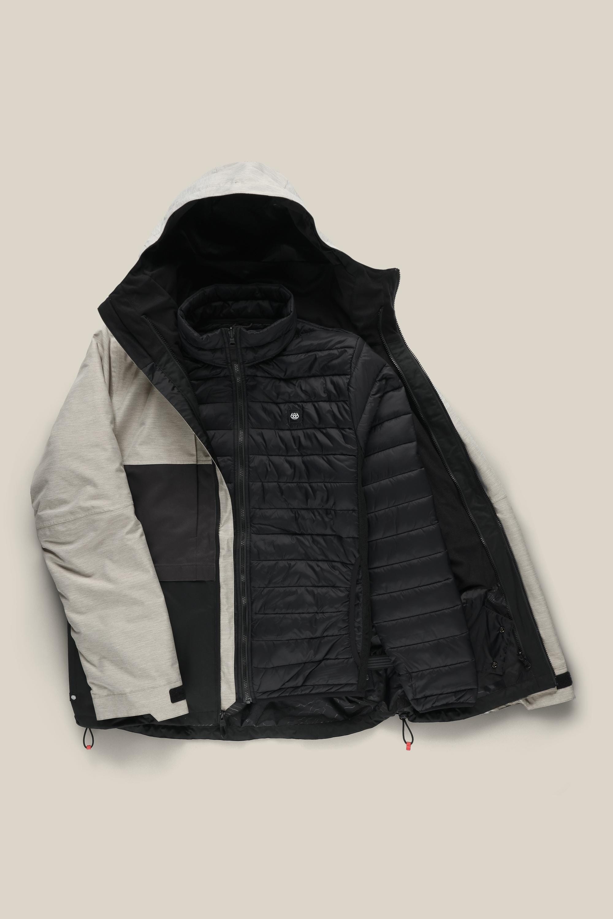 The 686 Men's SMARTY® 3-In-1 Form Jacket in beige and black is shown unzipped on a light beige background, revealing its quilted black inner layer.