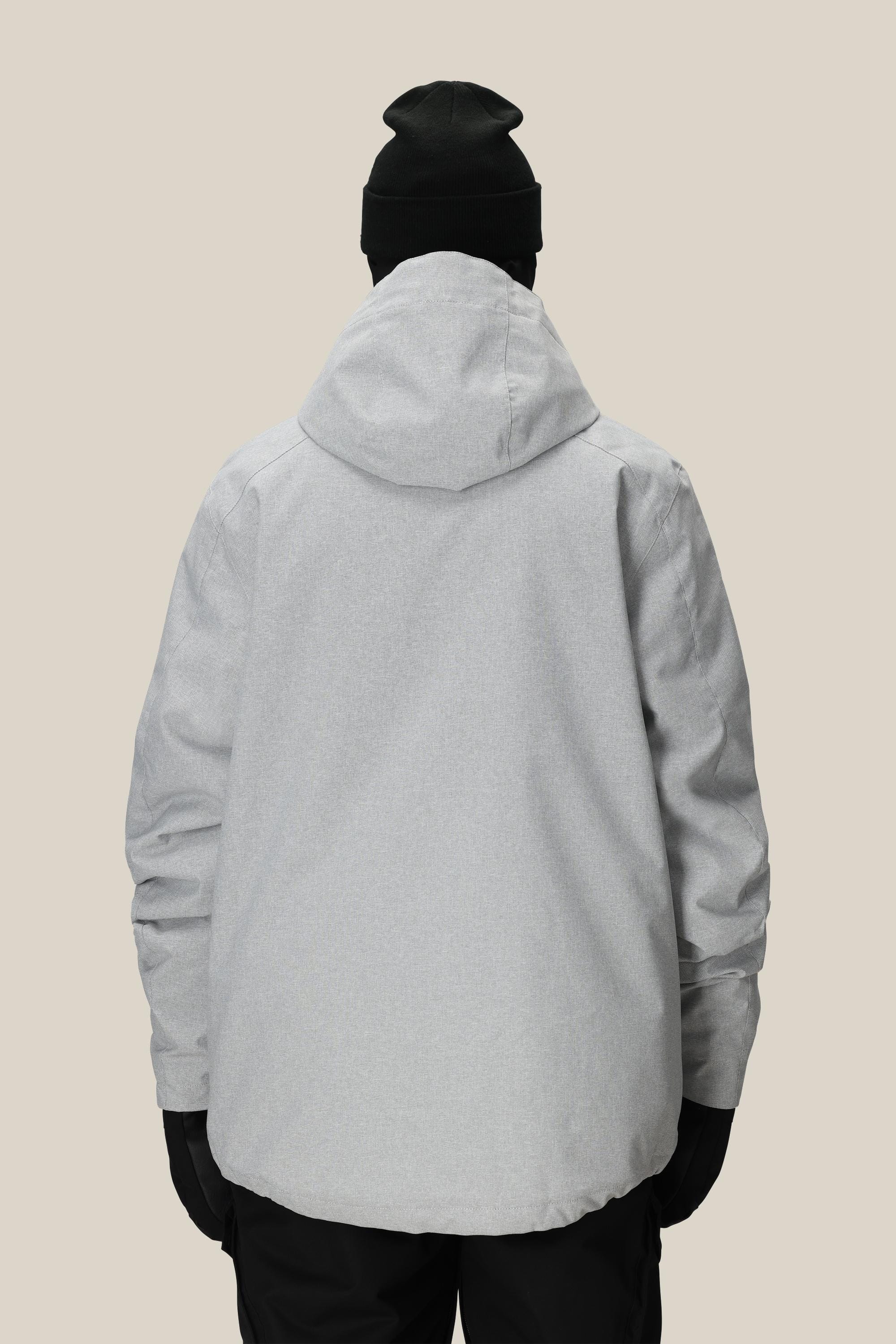 A person is shown from the back against a plain beige background wearing the 686 Men's Nightline™ Insulated Jacket in light gray, paired with a black beanie, black gloves, and black pants.