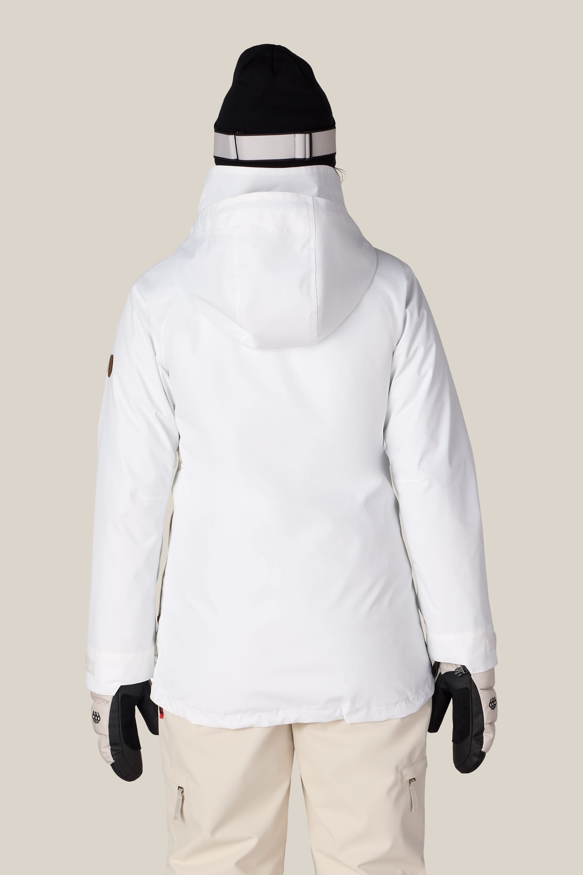 A person is shown from the back against a plain light background, wearing the 686 Women’s SMARTY® 3-In-1 Spellbound Jacket in white.