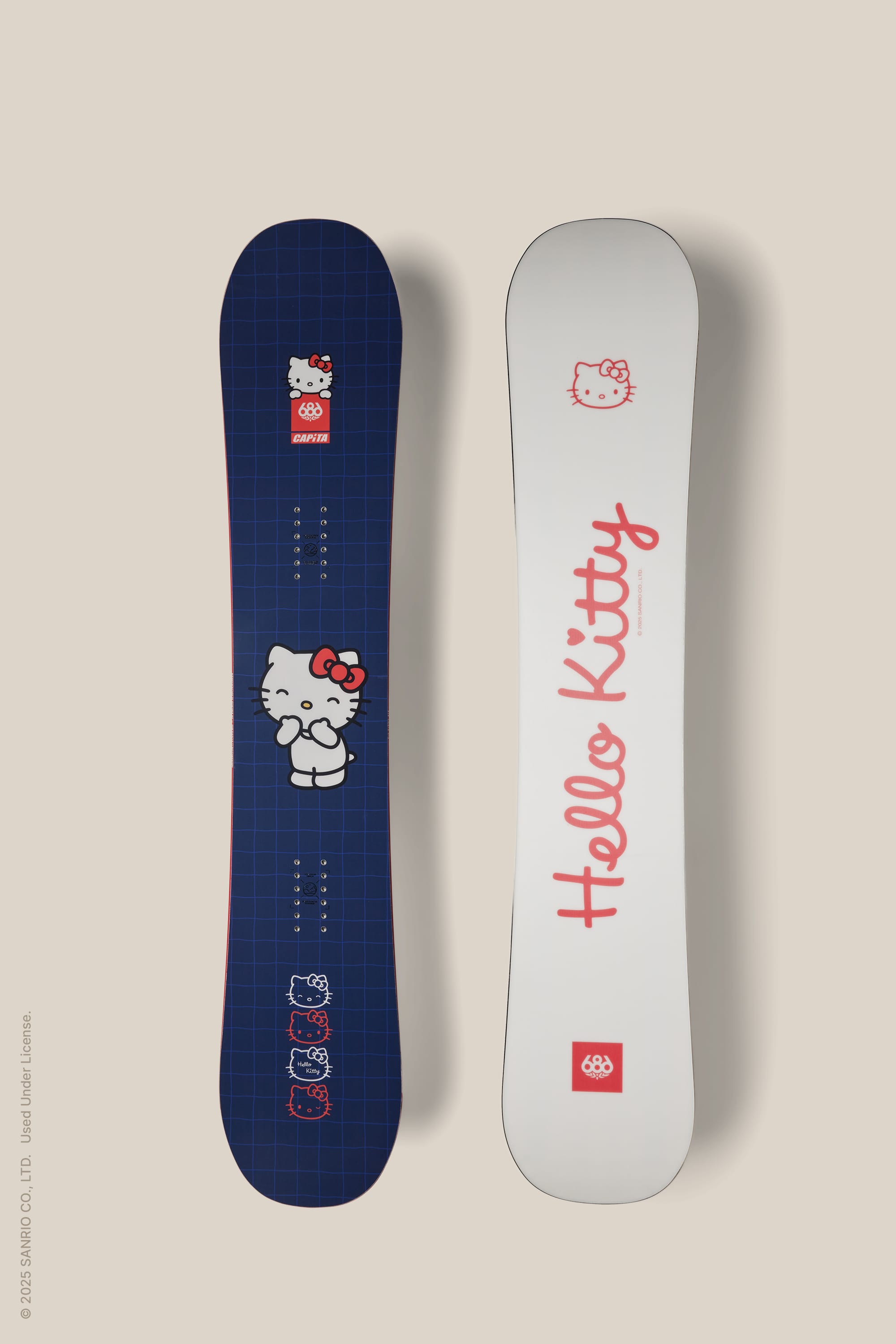 Two 686 Hello Kitty® Paradise Snowboards are shown: one is blue with small and large Hello Kitty graphics, the other is white featuring "Hello Kitty" in red cursive and a small Hello Kitty face near the top. Brand: 686.