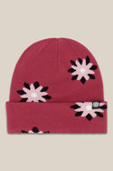 The 686 Womens Dazey Beanie is a red acrylic knit hat with a folded brim, pink and black flower pattern, and a small black tag with the white 686 logo—perfect for stylish womens winter wear.