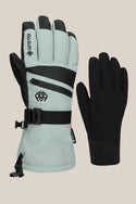 The 686 Women's GORE-TEX SMARTY® 3-In-1 Gauntlet Glove by 686 features a light gray glove with black accents, wrist strap, and zippered pocket, paired with a plain black fitted liner, displayed against a beige background.