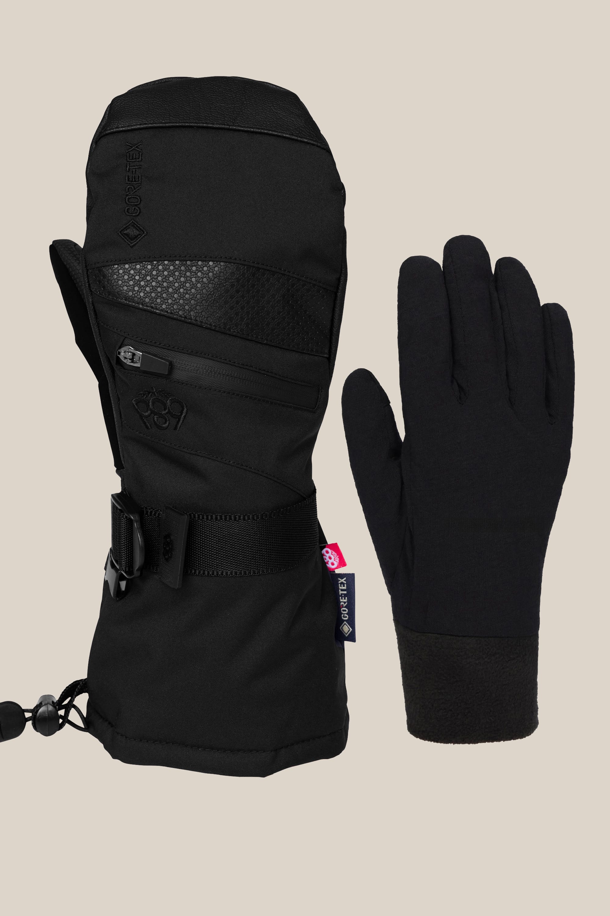 The 686 Women’s GORE-TEX SMARTY® 3-In-1 Gauntlet Mitt features an insulated, waterproof poly mitt with wrist strap and zipper, plus a slim fleece-lined glove, both from 686, displayed on a plain beige background.