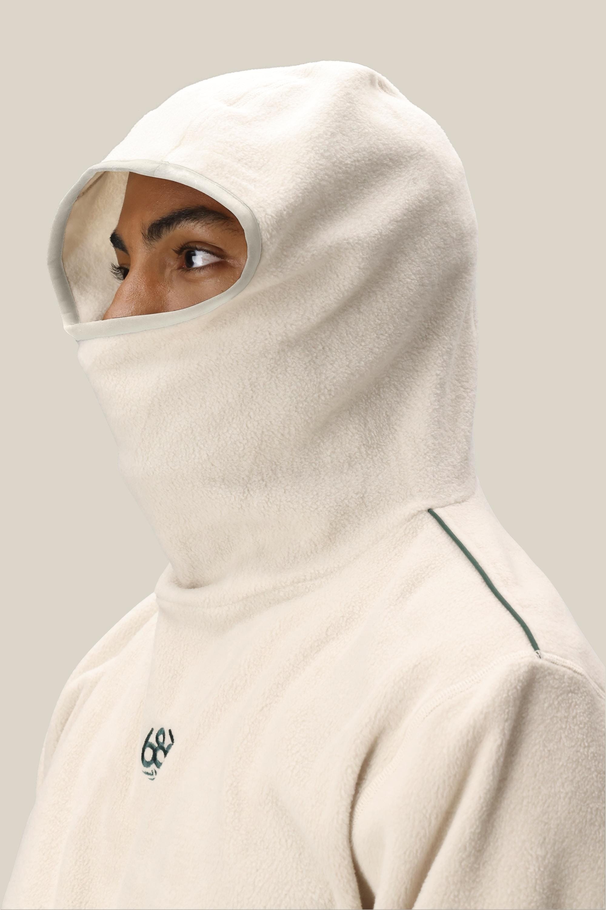 A person wears the 686 Mens Clava Fleece Hoody by 686, covering their head, neck, and lower face with only their eyes, nose, and part of their forehead visible against a plain light background.