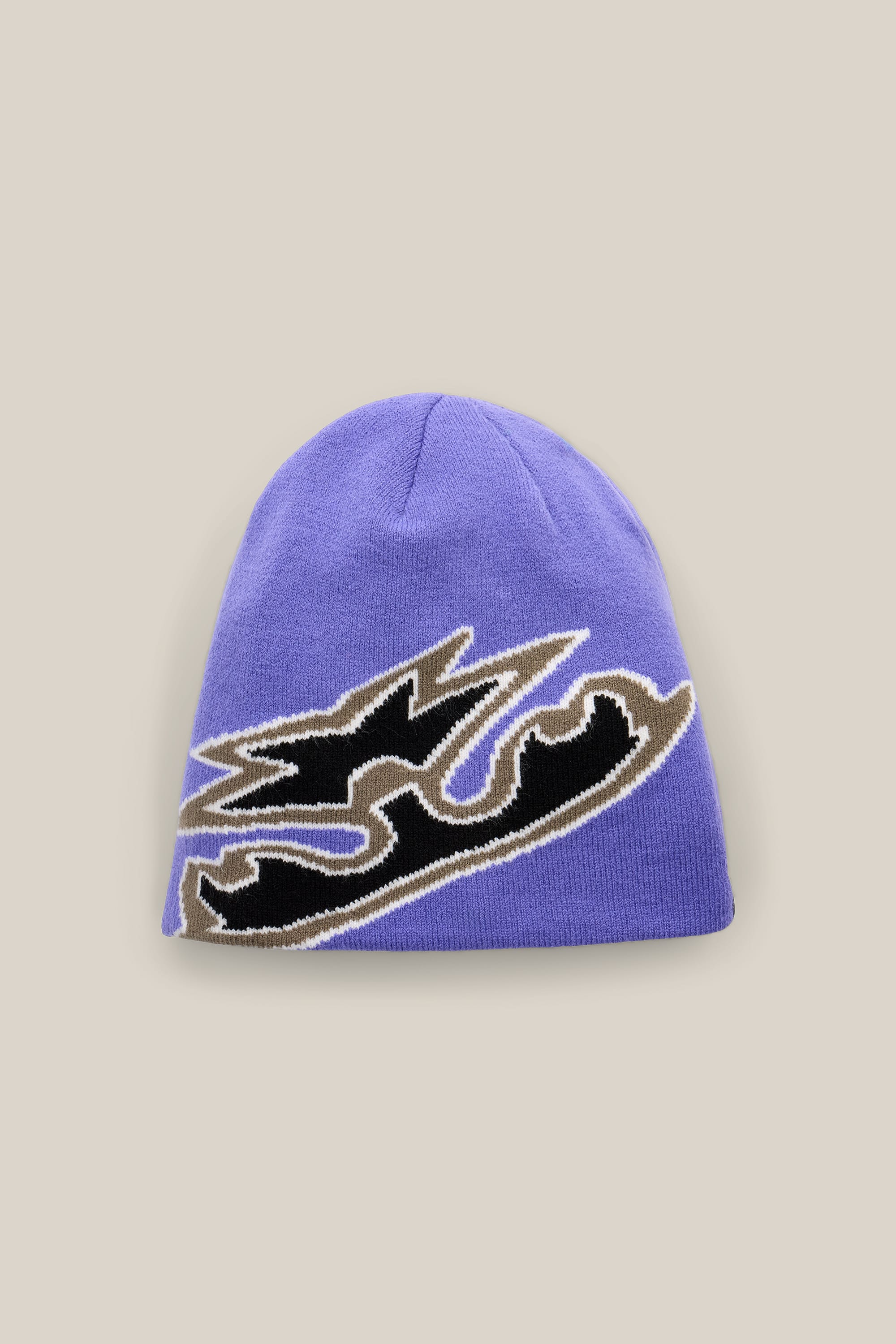 The 686 Jib Skully Beanie by 686 is a purple acrylic knit beanie showcasing a bold, abstract black and tan design on the front, displayed against a plain beige background.
