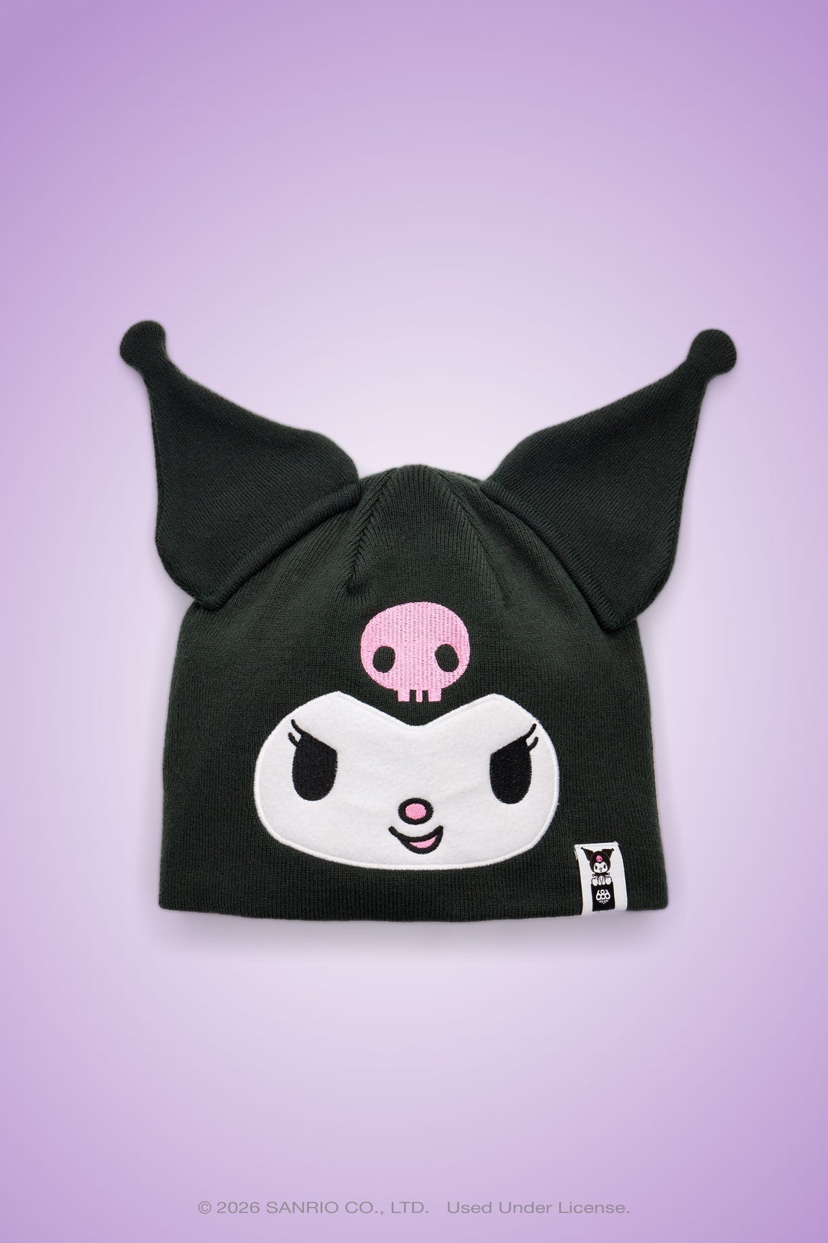 Introducing the 686 Women’s Kuromi™ Beanie by 686—a black acrylic knit beanie designed with playful, pointed ear-like tips and an embroidered cartoon face featuring Kuromi’s signature pink skull, expressive white eyes, and a mischievous smile. Set against a purple gradient background, this cozy accessory blends whimsical character style with everyday comfort to add a unique touch to any outfit.