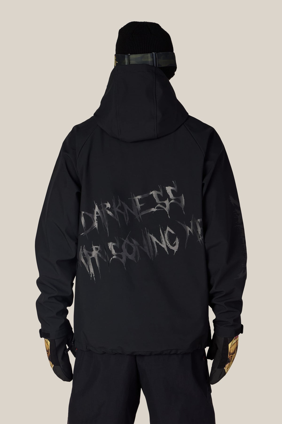 Back view of a person wearing a black polyester 686 Men’s Metallica Waterproof Hoody with the text DARKNESS IMPRISONING ME printed on the back.