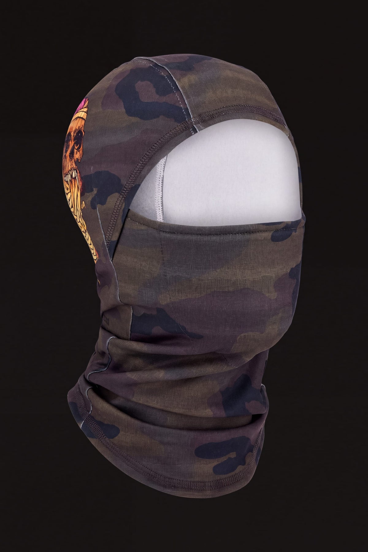 686 Hurra Hinged Balaclava in camouflage print with a skull graphic on the side, displayed on a mannequin head.