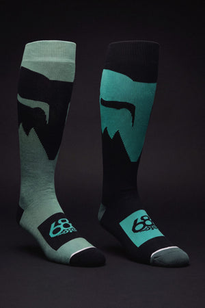 686 Men’s Fox Racing Socks - 2-Pack knee-high performance socks featuring a mountain silhouette graphic and the number 68 on the foot, in contrasting shades of teal and black.