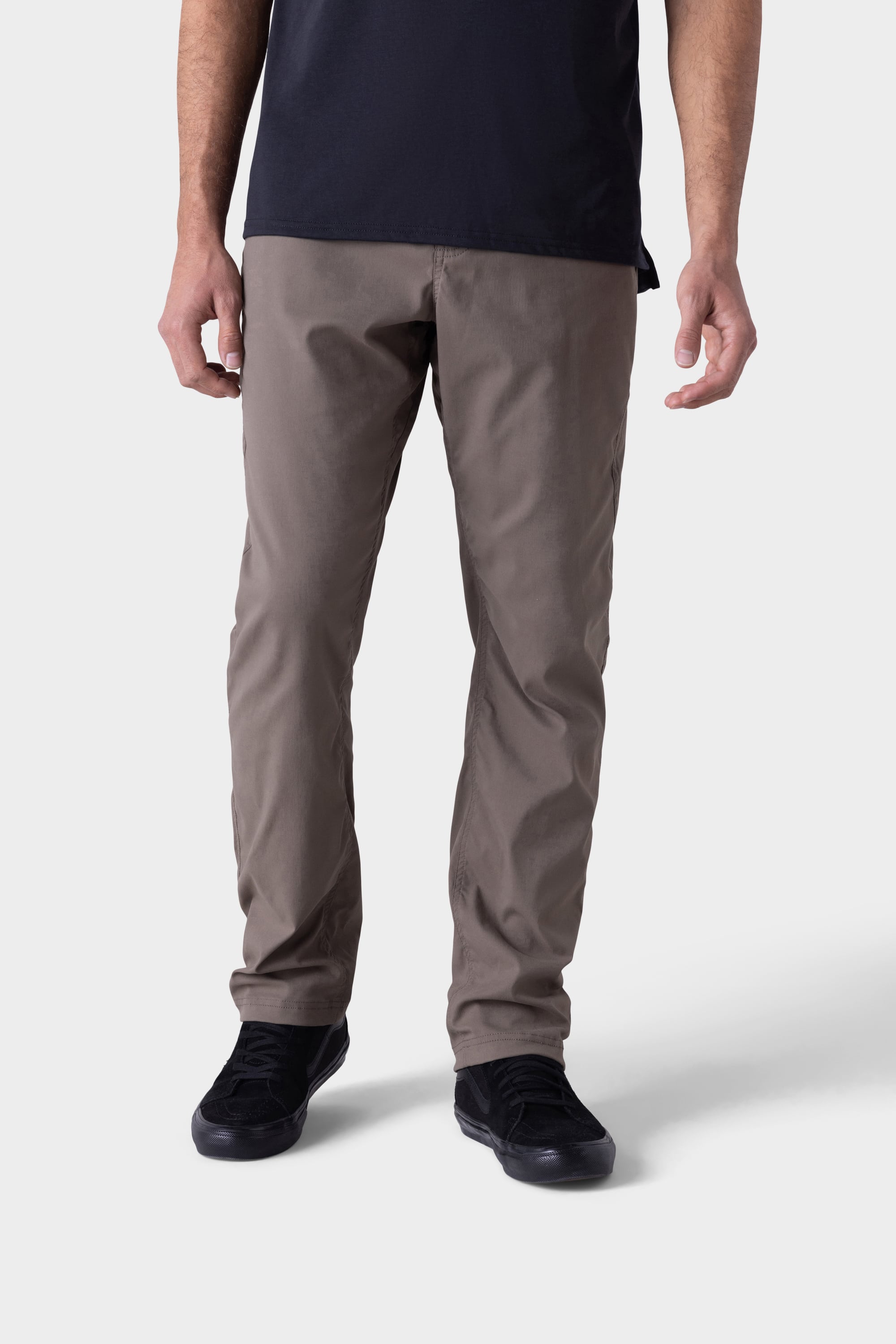 A person wearing 686 Mens Platform Bike Pant - Relaxed Fit in taupe stands against a plain light gray background, with only the lower half of the body visible.