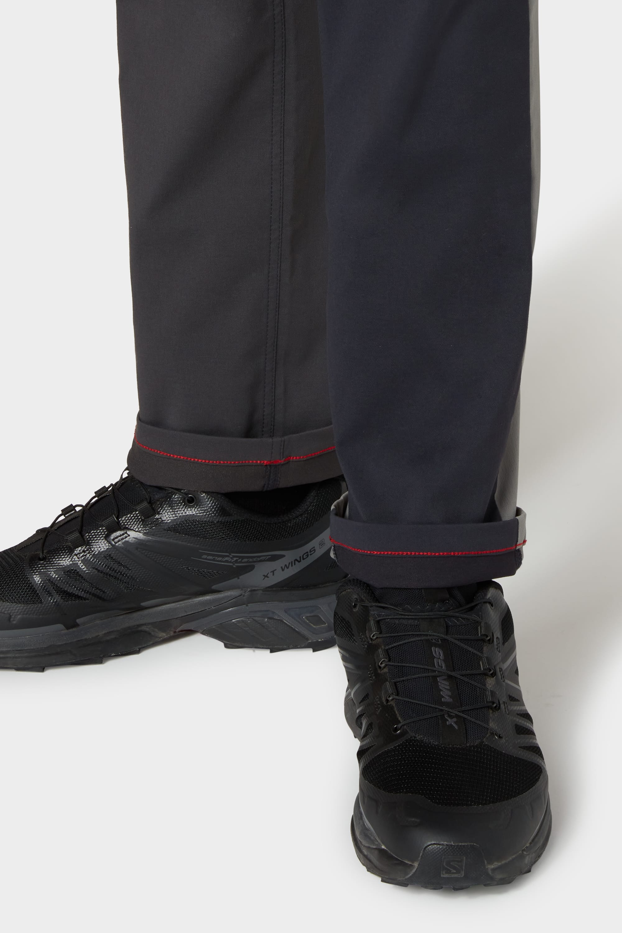 A person's legs and shoes feature the 686 Everywhere® Reclaimed Pant - Slim Fit by 686, made from deadstock fabrics to showcase a commitment to sustainability.