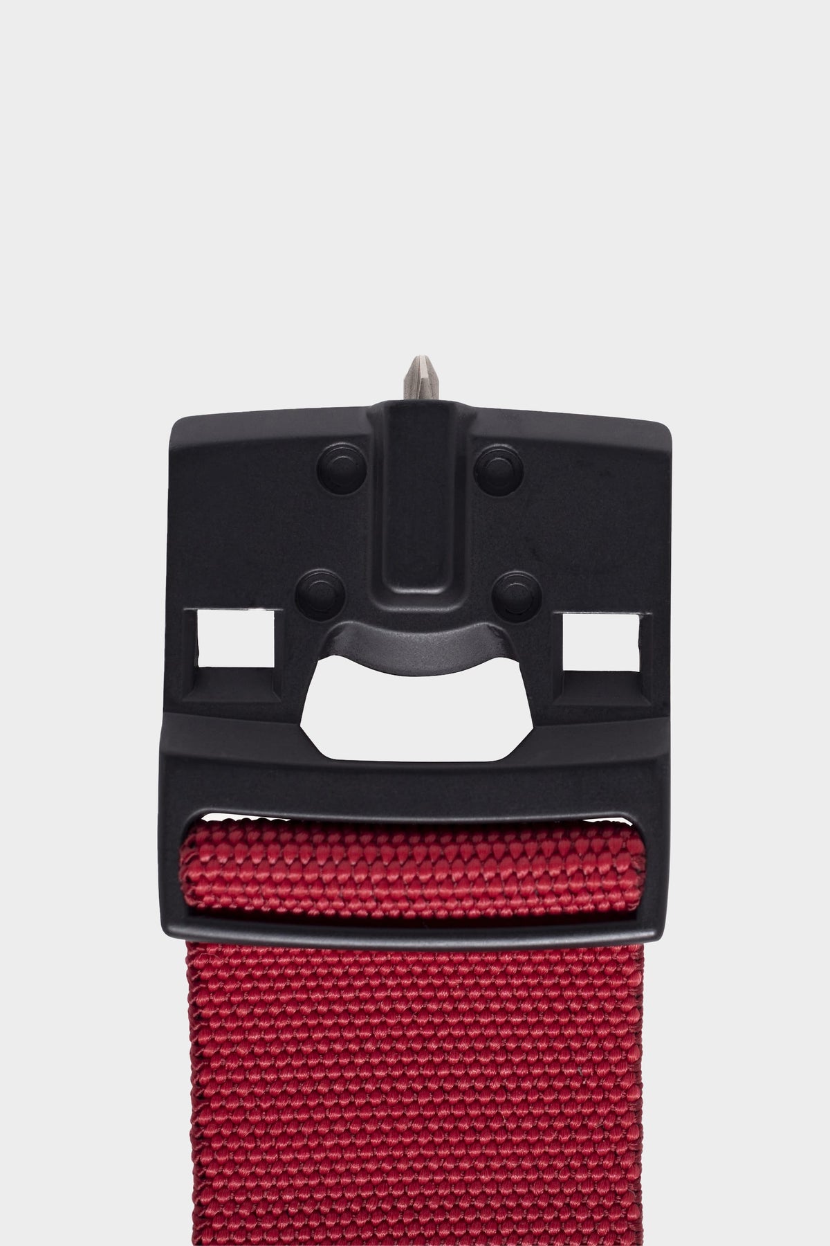 Close-up of the 686 Westwell Clicker Stretch Belt by 686, featuring a black plastic buckle with metal prong attached to a textured red strap, displayed on a plain white background.