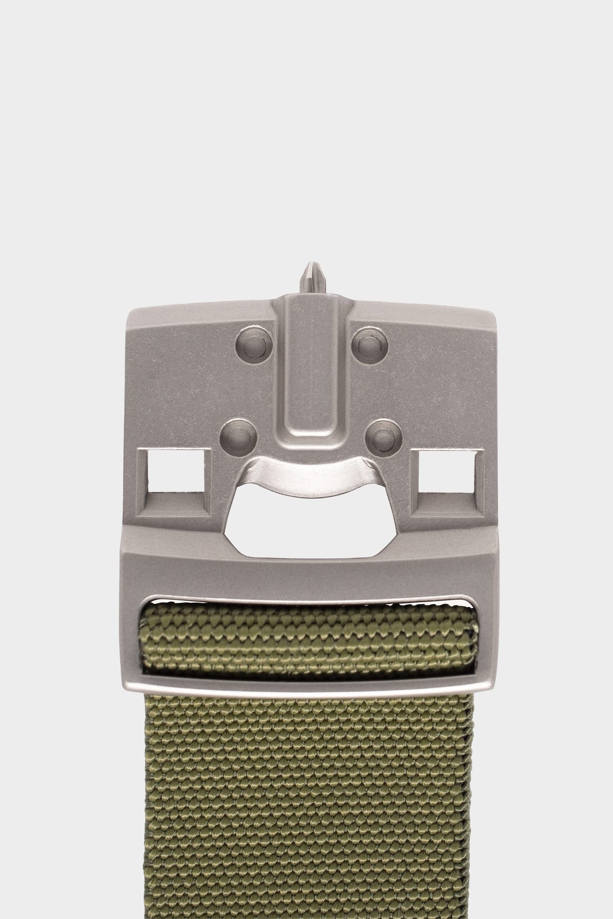 A close-up of the 686 Westwell Clicker Stretch Belt by 686 features a metallic buckle with geometric cutouts, resembling a stylized face, and a green woven strap, displayed on a plain white background.