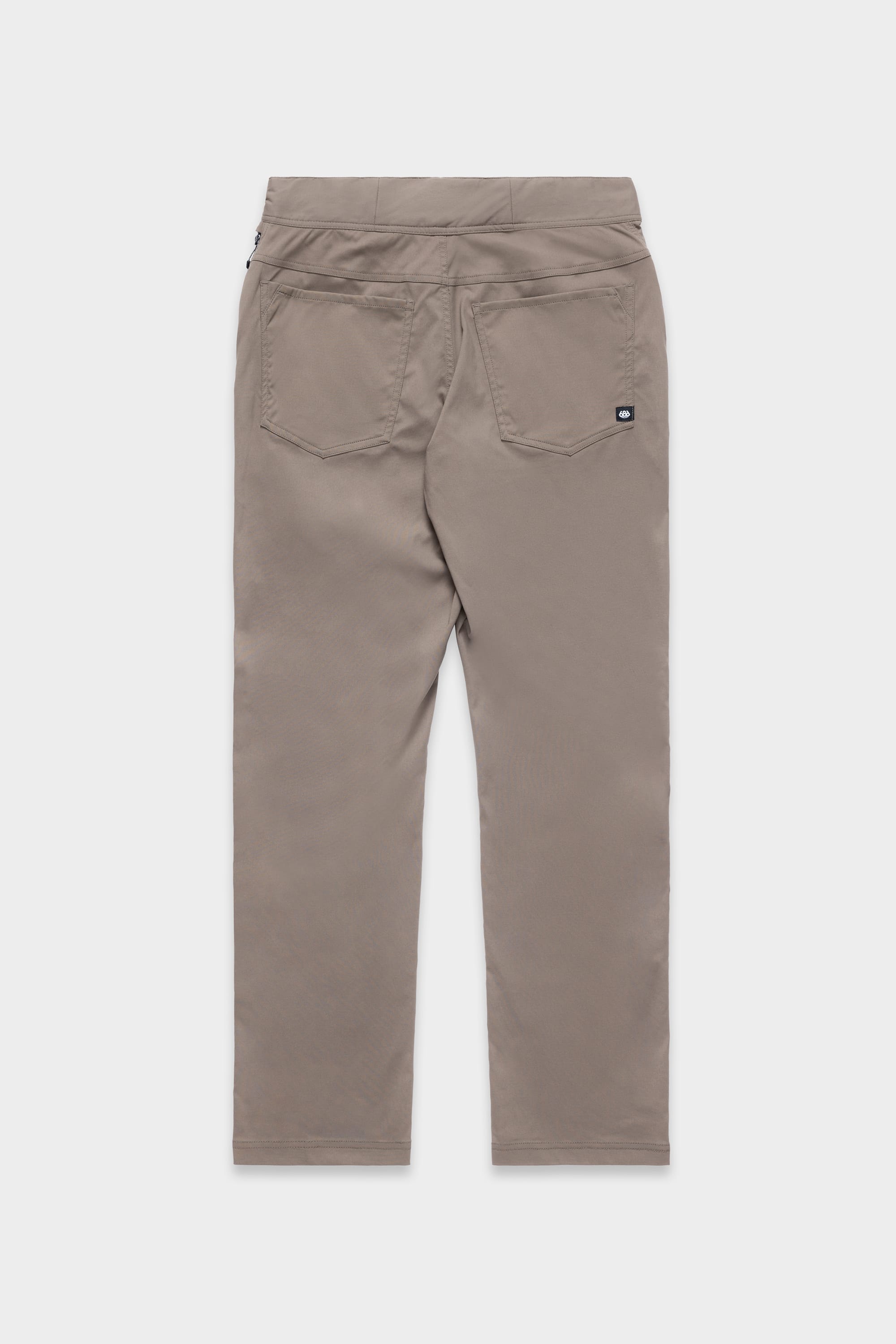 Back view of the 686 Mens Platform Bike Pant - Relaxed Fit in light brown, featuring two back pockets and a small rectangular black label on the right pocket, displayed against a plain white background.